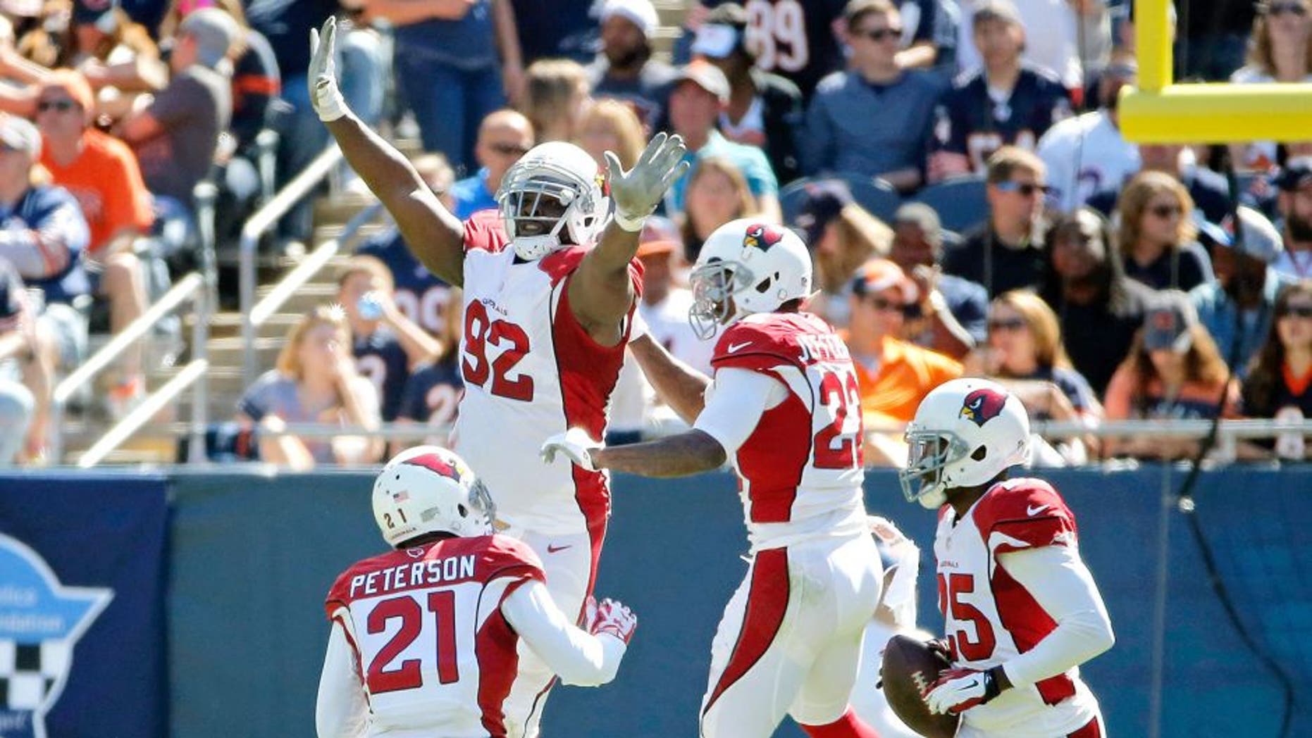 CHICAGO, IL - SEPTEMBER 20: Tony Jefferson #22 of the Arizona Cardinals celebrates with Frostee Rucker #92 and Patrick Peterson #21 after making an interception for a touchdown against the Chicago Bears during the second quarter at Soldier Field on September 20, 2015 in Chicago, Illinois. (Photo by Jon Durr/Getty Images)