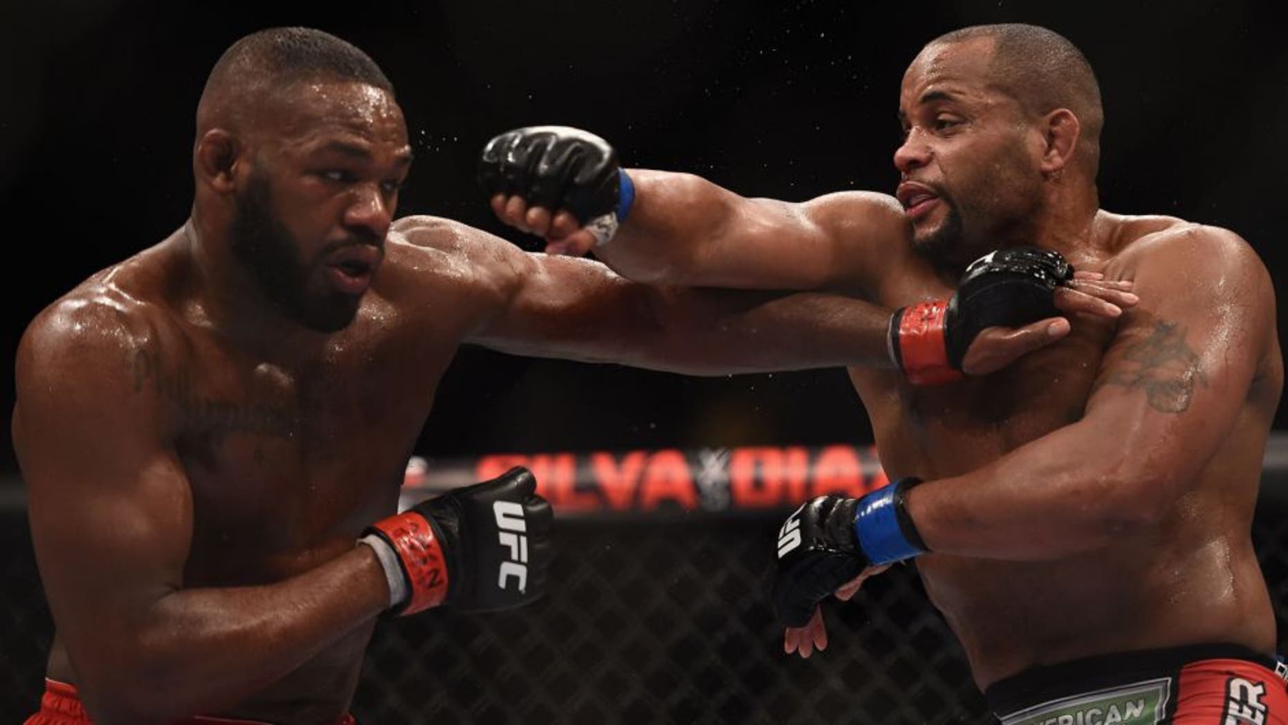 LAS VEGAS, NV - JANUARY 03: Jon Jones (L) and Daniel Cormier (R) exchange punches in their UFC light heavyweight championship bout during the UFC 182 event at the MGM Grand Garden Arena on January 3, 2015 in Las Vegas, Nevada. (Photo by Jeff Bottari/Zuffa LLC/Zuffa LLC via Getty Images)