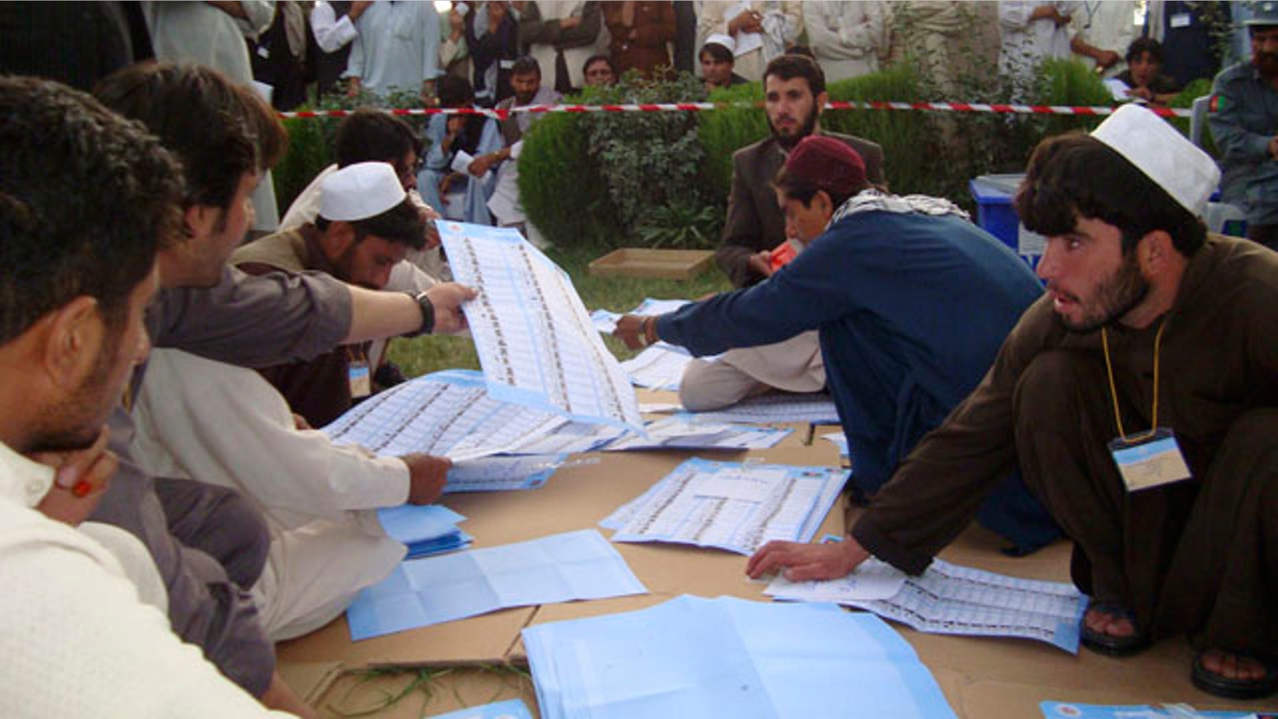 Sept. 20: Election workers count votes at the regional counting center in Khost, Afghanistan.