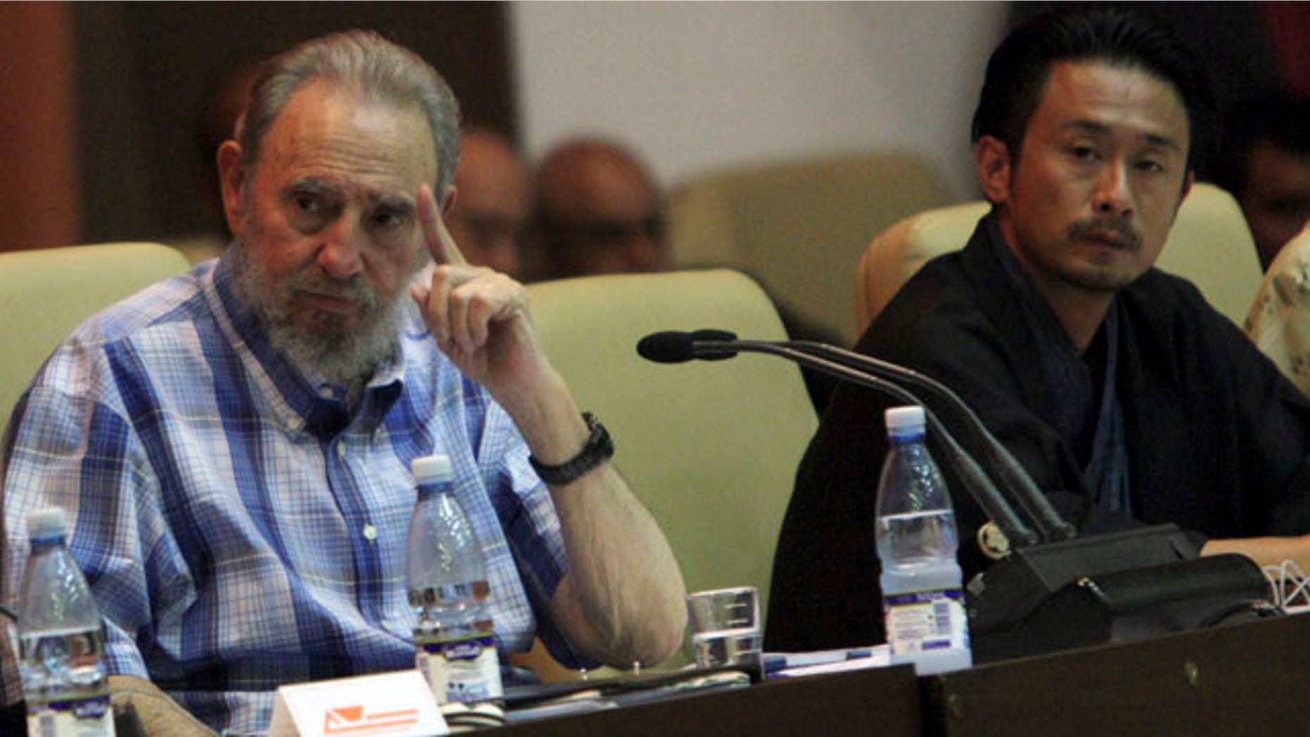 Sept. 21: Cuba's former President Fidel Castro, left, attends a meeting with members of the Peace Boat organization in Havana, Cuba.