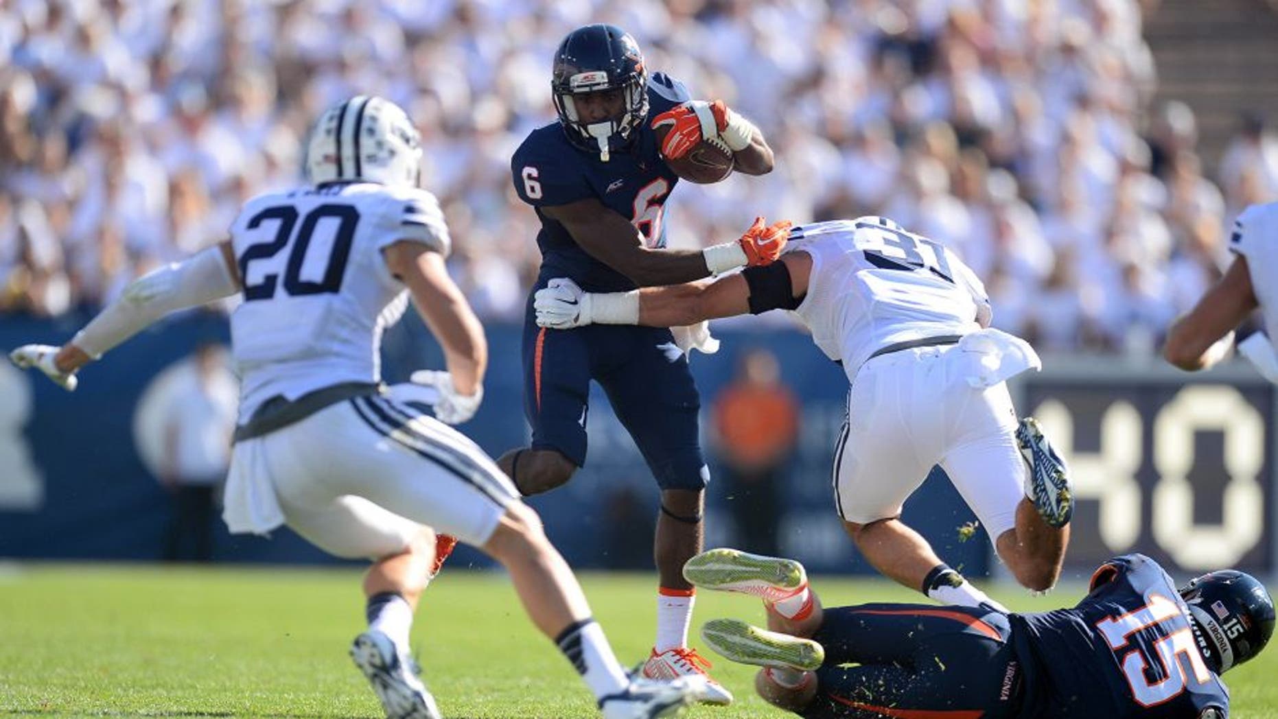 Sep 20, 2014; Provo, UT, USA; Virginia Cavaliers wide receiver Darius Jennings (6) shakes the tackle of Brigham Young Cougars linebacker Sae Tautu (31) during the second half at Lavell Edwards Stadium. The Cougars won the game 41-33. Mandatory Credit: Joe Camporeale-USA TODAY Sports