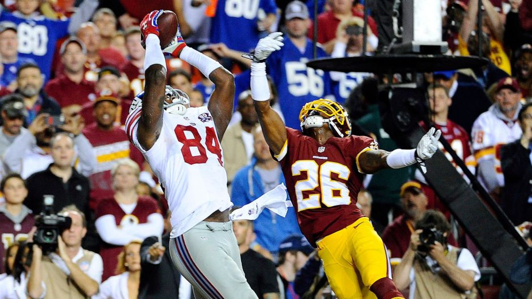 Sep 25, 2014; Landover, MD, USA; New York Giants tight end Larry Donnell (84) catches a touchdown pass as Washington Redskins strong safety Bashaud Breeland (26) defends during the first half at FedEx Field. Mandatory Credit: Brad Mills-USA TODAY Sports
