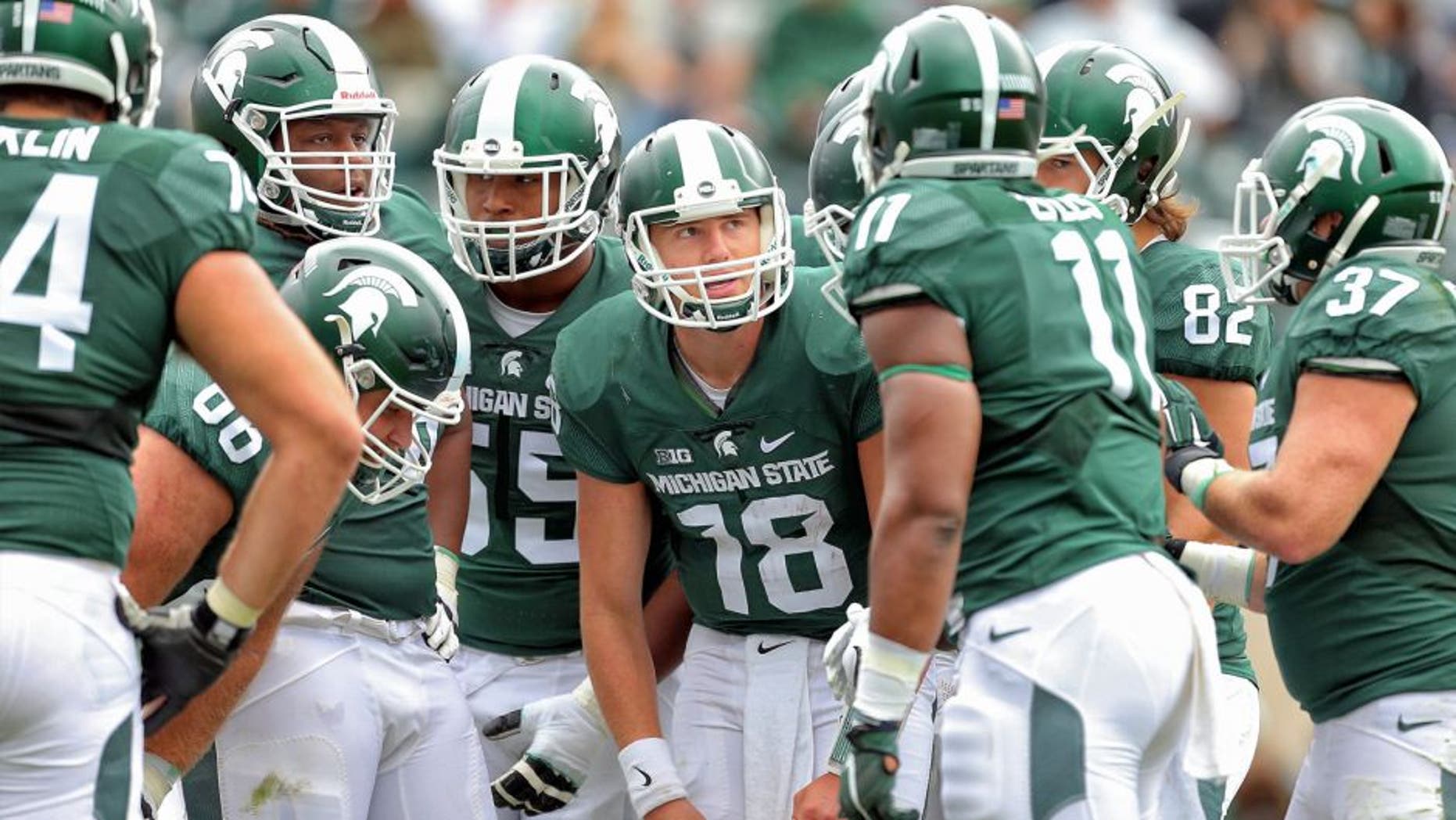 Sep 19, 2015; East Lansing, MI, USA; Michigan State Spartans quarterback Connor Cook (18) call a play in the huddle during the 2nd half of a game at Spartan Stadium. MSU won 35-21. Mandatory Credit: Mike Carter-USA TODAY Sports