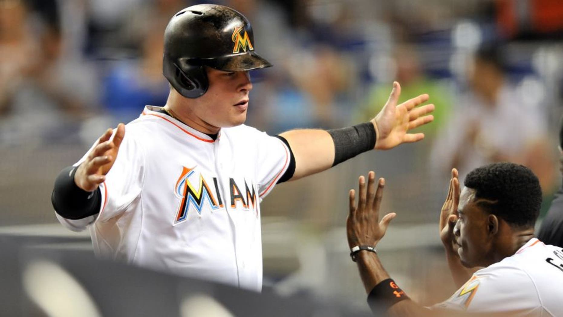 Sep 25, 2015; Miami, FL, USA; Miami Marlins second baseman Dee Gordon (right) celebrates after Miami Marlins first baseman Justin Bour (left) hit a three run homer during the first inning against the Atlanta Braves at Marlins Park. Mandatory Credit: Steve Mitchell-USA TODAY Sports