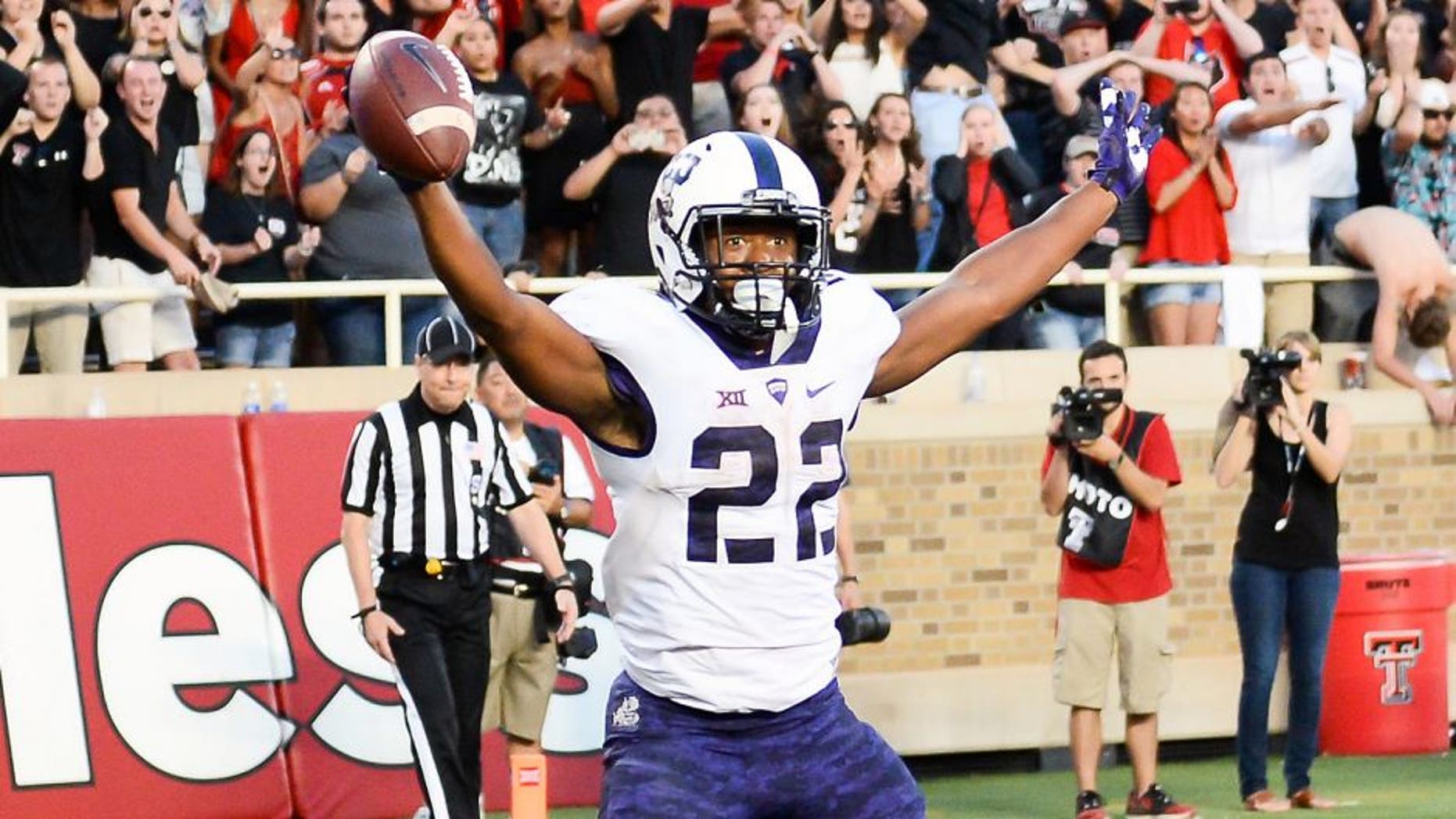 LUBBOCK, TX - SEPTEMBER 26: Aaron Green #22 of the TCU Horned Frogs catches a tipped ball in the end zone for the game winning touchdown late in the 4th quarter against the Texas Tech Red Raiders on September 26, 2015 at Jones AT&T Stadium in Lubbock, Texas. TCU won the game 55-52. (Photo by John Weast/Getty Images)