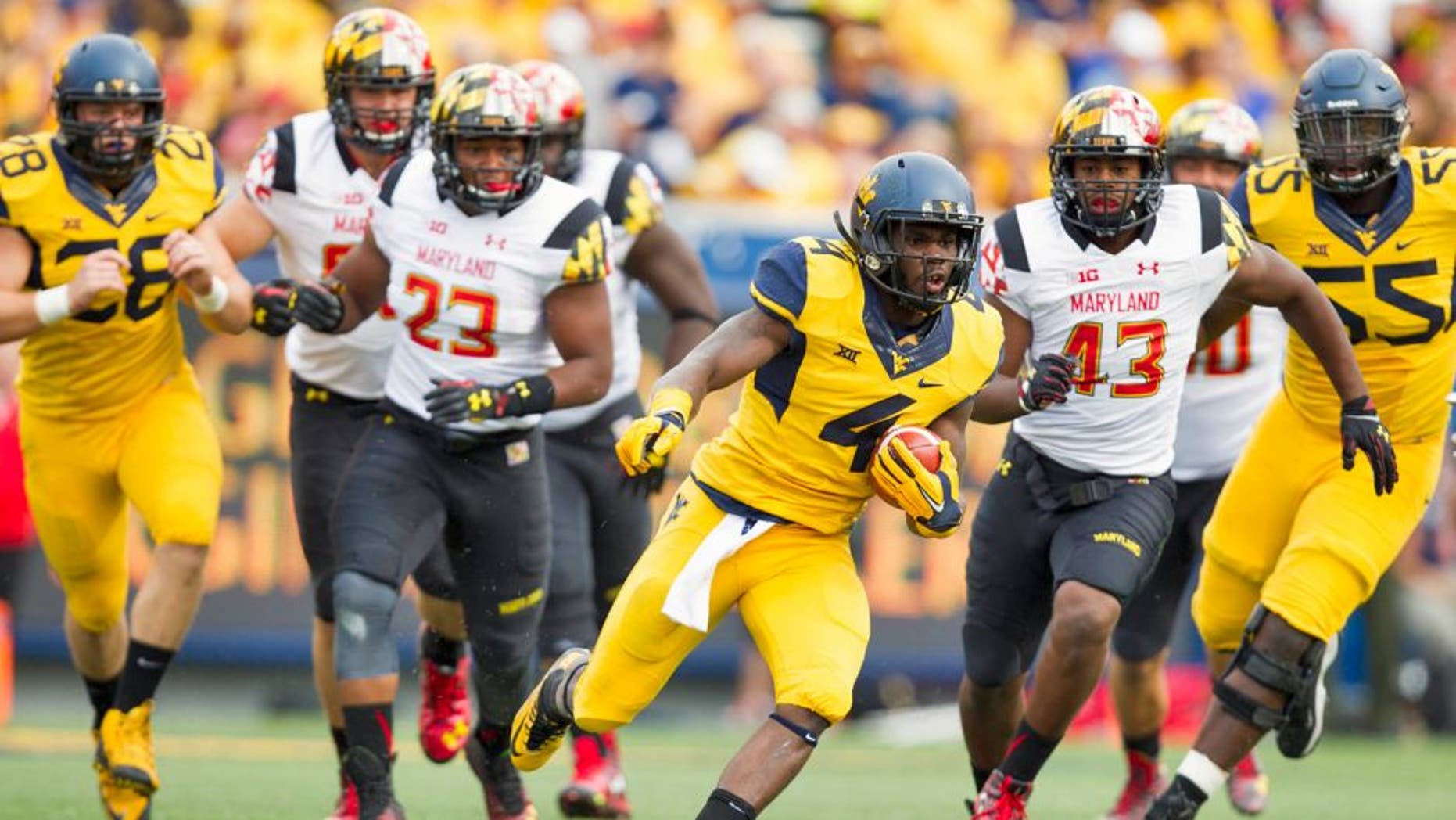 Sep 26, 2015; Morgantown, WV, USA; West Virginia Mountaineers running back Wendell Smallwood runs the ball against the Maryland Terrapins during the first quarter at Milan Puskar Stadium. Mandatory Credit: Ben Queen-USA TODAY Sports