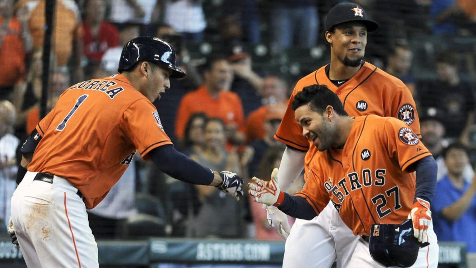 HOUSTON, TX - SEPTEMBER 26: Jose Altuve #27 of the Houston Astros celebrates his solo home run with Carlos Correa #1 during the eighth inning against theTexas Rangers at Minute Maid Park on September 26, 2015 in Houston, Texas. (Photo by Eric Christian Smith/Getty Images)