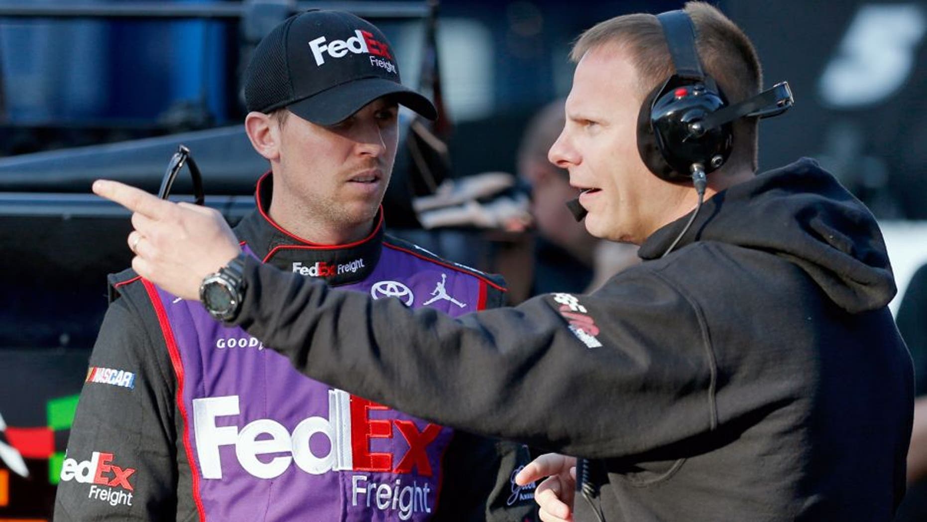 BRISTOL, TN - APRIL 18: Denny Hamlin, driver of the #11 FedEx Freight Toyota, talks to his crew chief, Dave Rogers, in the garage area during practice for the NASCAR Sprint Cup Series Food City 500 at Bristol Motor Speedway on April 18, 2015 in Bristol, Tennessee. (Photo by Todd Warshaw/NASCAR via Getty Images)