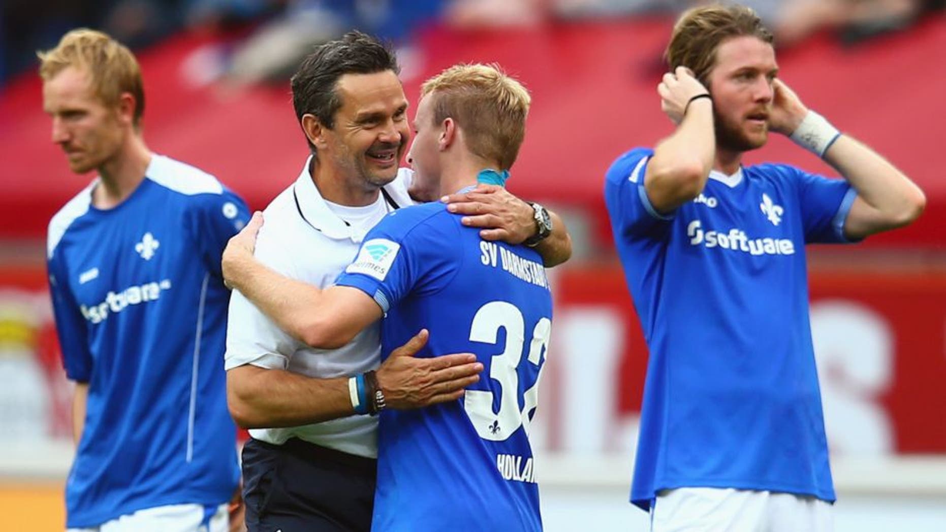 LEVERKUSEN, GERMANY - SEPTEMBER 12: Head coach Dirk Schuster of Darmstadt hugs Fabian Holland after the Bundesliga match between Bayer Leverkusen and SV Darmstadt 98 at BayArena on September 12, 2015 in Leverkusen, Germany. (Photo by Alex Grimm/Bongarts/Getty Images)