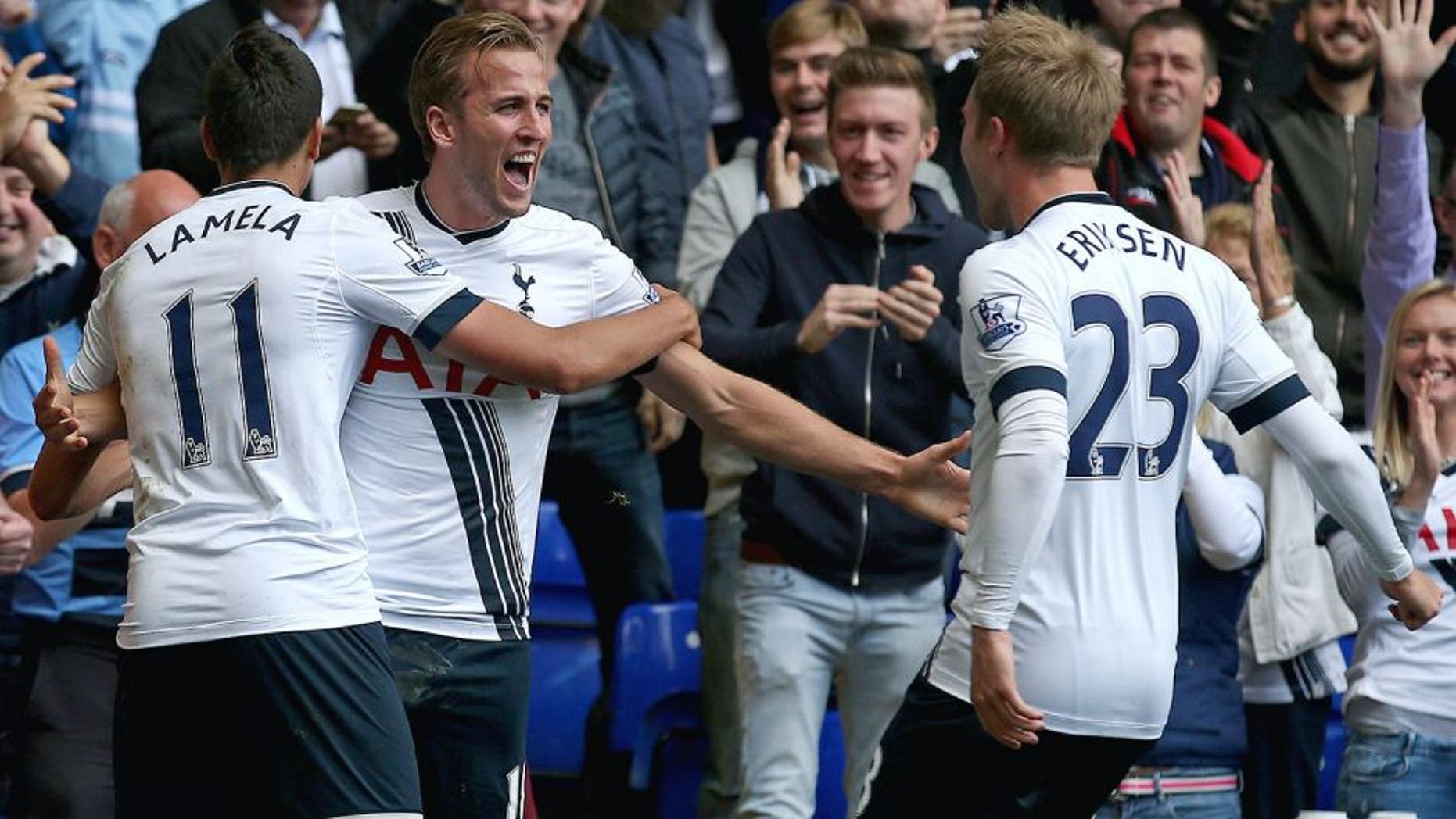 Tottenham Hotspur's English striker Harry Kane (2nd L) celebrates with Tottenham Hotspur's Argentinian midfielder Erik Lamela and Tottenham Hotspur's Danish midfielder Christian Eriksen (R) after scoring their third goal during the English Premier League football match between Tottenham Hotspur and Manchester City at White Hart Lane in north London on September 26, 2015. AFP PHOTO / JUSTIN TALLIS RESTRICTED TO EDITORIAL USE. No use with unauthorized audio, video, data, fixture lists, club/league logos or 'live' services. Online in-match use limited to 75 images, no video emulation. No use in betting, games or single club/league/player publications. (Photo credit should read JUSTIN TALLIS/AFP/Getty Images)