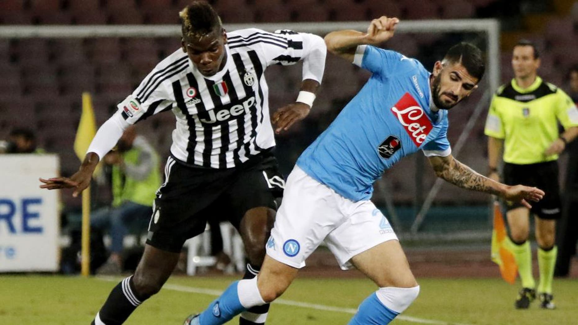 Juventus' French midfielder Paul Pogba (L) vies with Napoli's Albanian defender Elseid Hysaj during the Italian Serie A football match SSC Napoli vs FC Juventus on September 26, 2015 at the San Paolo stadium in Naples. AFP PHOTO / CARLO HERMANN (Photo credit should read CARLO HERMANN/AFP/Getty Images)