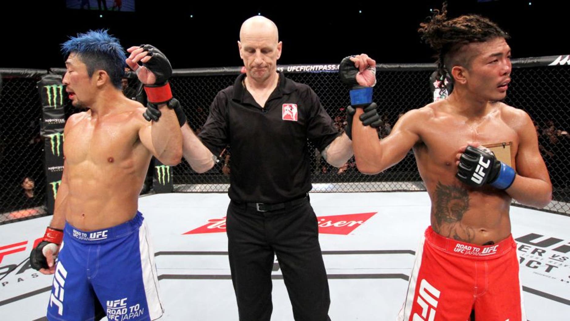 SAITAMA, JAPAN - SEPTEMBER 27: (From L to R) Mizuto Hirota of Japan and Teruto Ishihara of Japan react after hearing their featherweight bout was a majority draw during the UFC event at the Saitama Super Arena on September 27, 2015 in Saitama, Japan. (Photo by Mitch Viquez/Zuffa LLC/Zuffa LLC via Getty Images)
