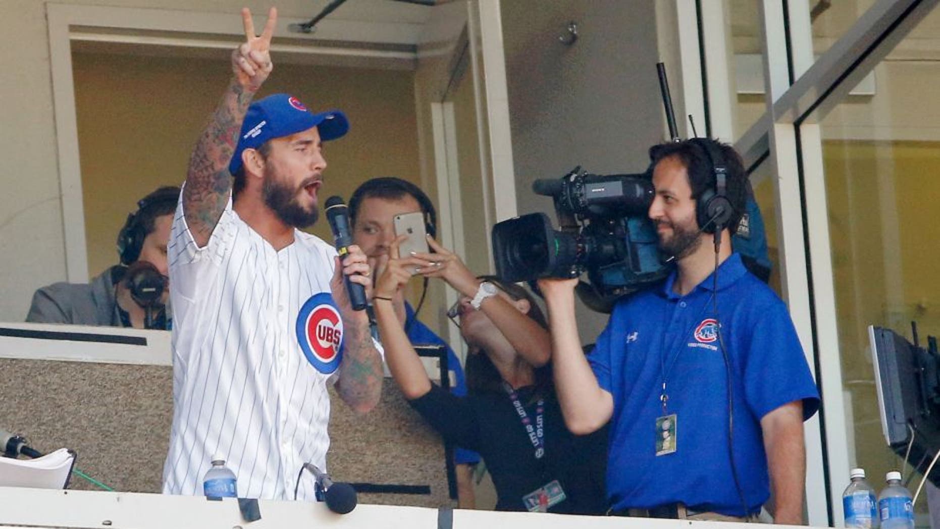 CHICAGO, IL - SEPTEMBER 26: UFC fighter CM Punk sings the seventh inning stretch during the game between the Chicago Cubs and the Pittsburgh Pirates at Wrigley Field on September 26, 2015 in Chicago, Illinois. (Photo by Jon Durr/Getty Images)