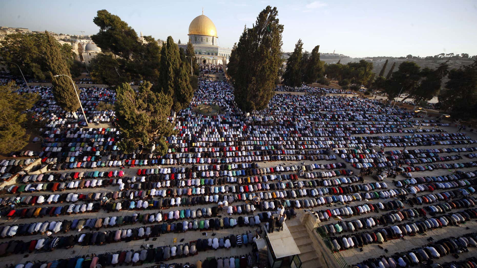 FILE - In this Thursday, Sept. 24, 2015. file photo, Palestinians pray during the Muslim holiday of Eid al-Adha, near the Dome of the Rock Mosque.