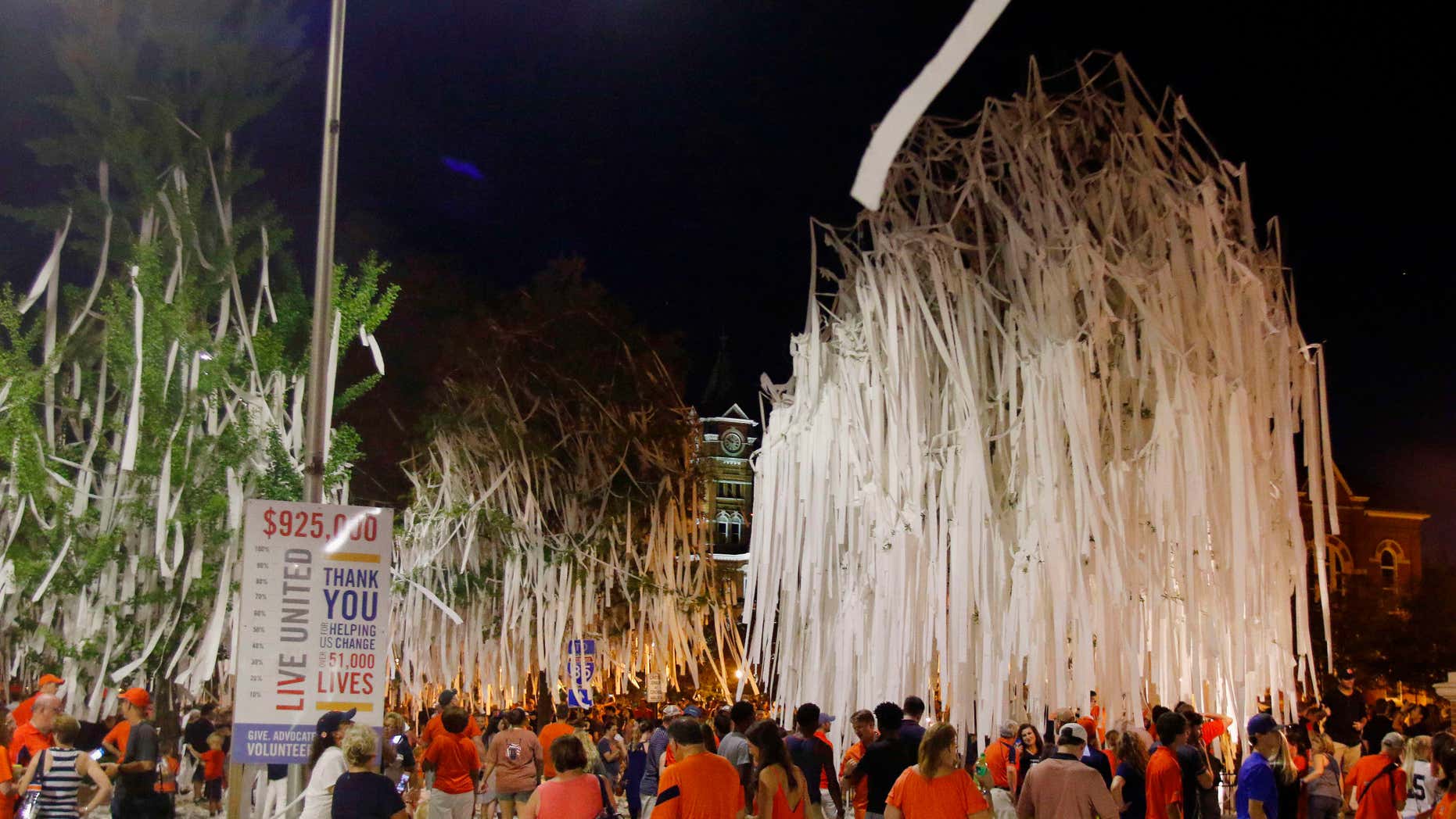 Fans celebrate at Toomer's Corner after Auburn defeated LSU 18-13 in an NCAA college football game Saturday, Sept. 24, 2016, in Auburn, Ala.