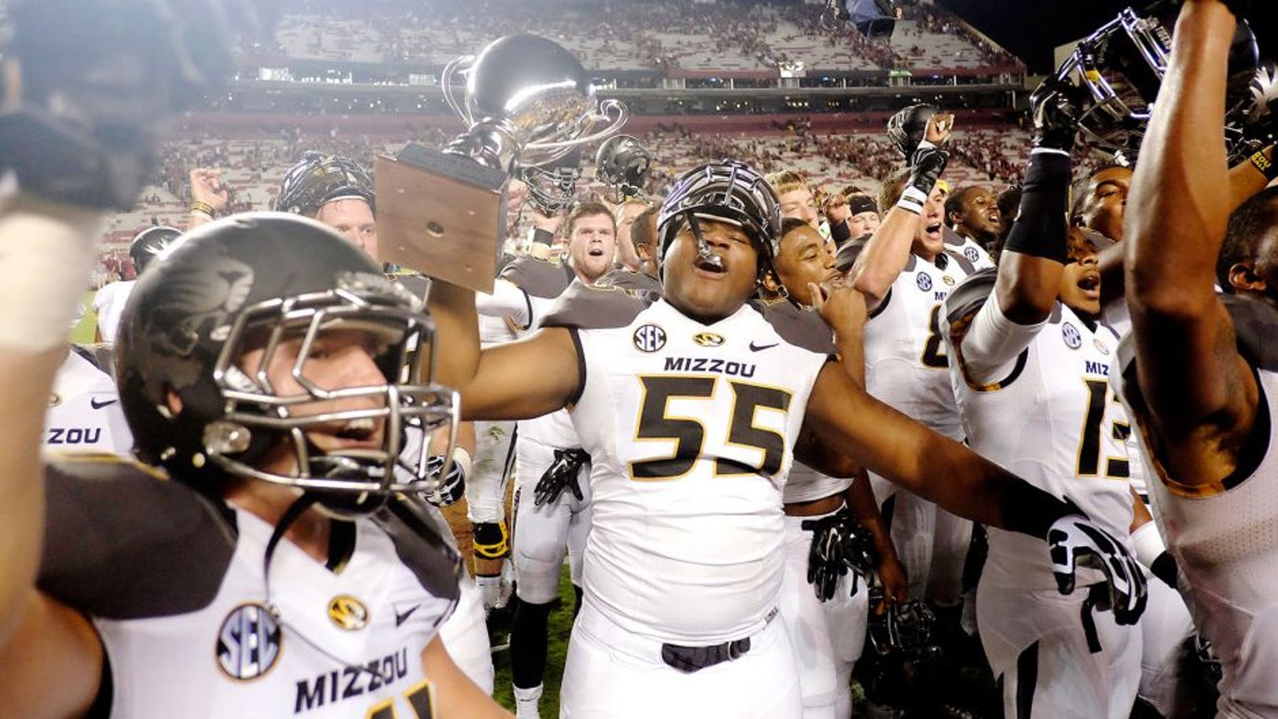 COLUMBIA, SC - SEPTEMBER 27: Offensive Lineman Nate Crawford #55 of the Missouri Tigers hoists the Mayor's Cup after the game against the South Carolina Gamecocks on September 27, 2014 at Williams-Brice Stadium in Columbia, South Carolina. Missouri won 21-20. (Photo by Todd Bennett/GettyImages)