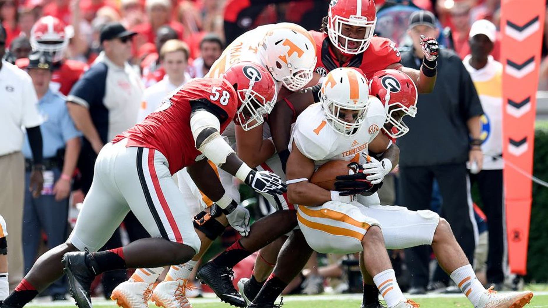 Sep 27, 2014; Athens, GA, USA; Tennessee Volunteers running back Jalen Hurd (1) is tackled by Georgia Bulldogs defensive end Sterling Bailey (58) linebacker Ramik Wilson (51) and linebacker Jordan Jenkins (59) during the first quarter at Sanford Stadium. Mandatory Credit: Dale Zanine-USA TODAY Sports