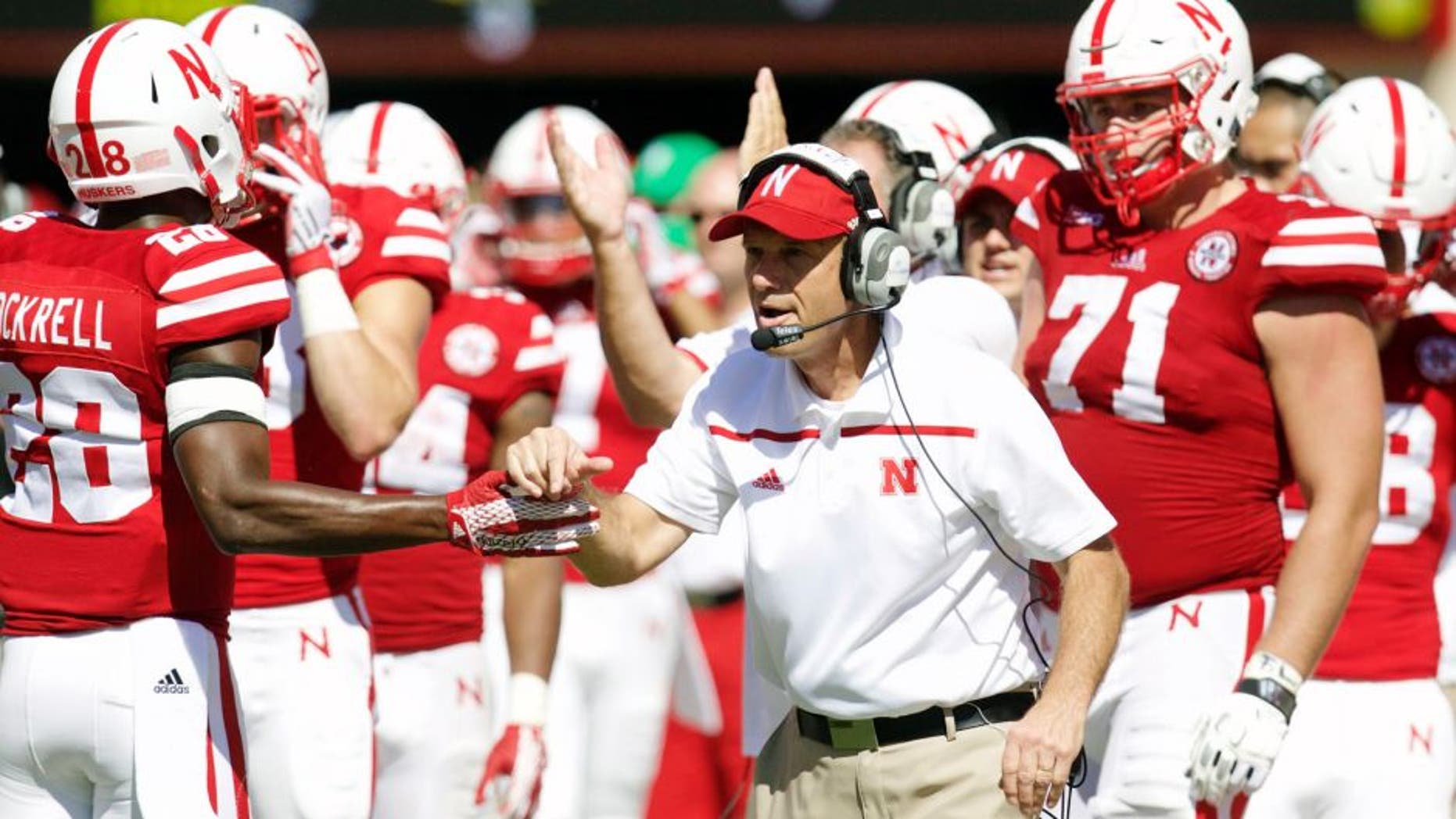Sep 26, 2015; Lincoln, NE, USA; Nebraska Cornhuskers head coach Mike Riley congratulates defensive back Byerson Cockerel (28) during the game against the Southern Mississippi Golden Eagles in the second half at Memorial Stadium. Nebraska won 36-28. Mandatory Credit: Bruce Thorson-USA TODAY Sports