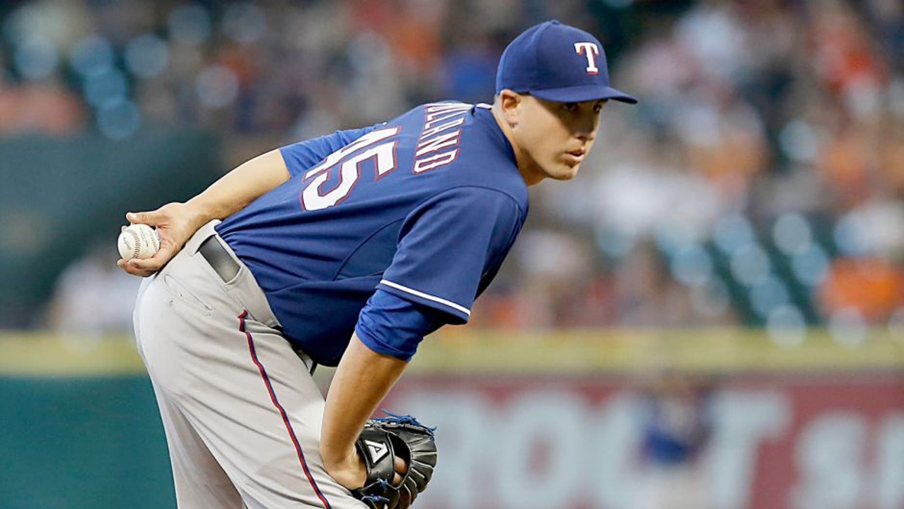 Sep 26, 2015; Houston, TX, USA; Texas Rangers starting pitcher Derek Holland (45) pitches against the Houston Astros in the first inning at Minute Maid Park. Mandatory Credit: Thomas B. Shea-USA TODAY Sports