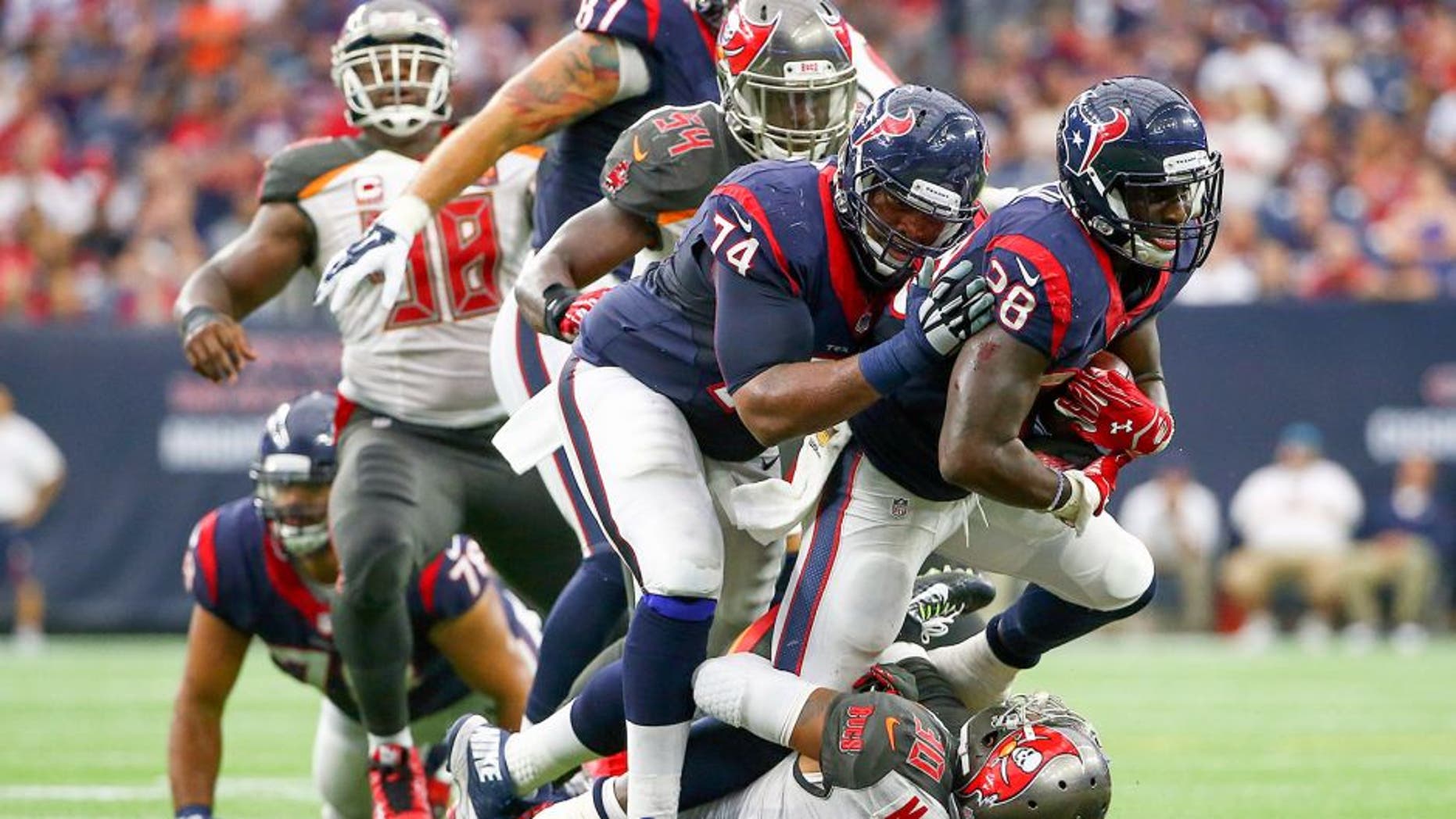 Sep 27, 2015; Houston, TX, USA; Houston Texans running back Alfred Blue (28) runs over Tampa Bay Buccaneers free safety Bradley McDougald (30) during the first half at NRG Stadium. Mandatory Credit: Kevin Jairaj-USA TODAY Sports