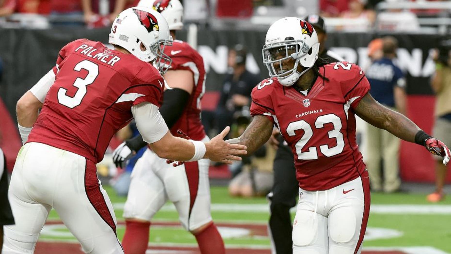 GLENDALE, AZ - SEPTEMBER 27: Chris Johnson #23 of the Arizona Cardinals celebrates with teammate Carson Palmer #3 after scoring a touchdown during the first half against the San Francisco 49ers at University of Phoenix Stadium on September 27, 2015 in Glendale, Arizona. (Photo by Norm Hall/Getty Images)