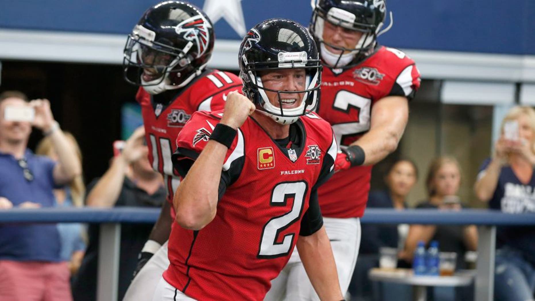 Sep 27, 2015; Arlington, TX, USA; Atlanta Falcons quarterback Matt Ryan (2) celebrates with receiver Julio Jones (11) and fullback Patrick MiMarco (42) after their fourth quarter touchdown against the Dallas Cowboys at AT&T Stadium. Mandatory Credit: Matthew Emmons-USA TODAY Sports