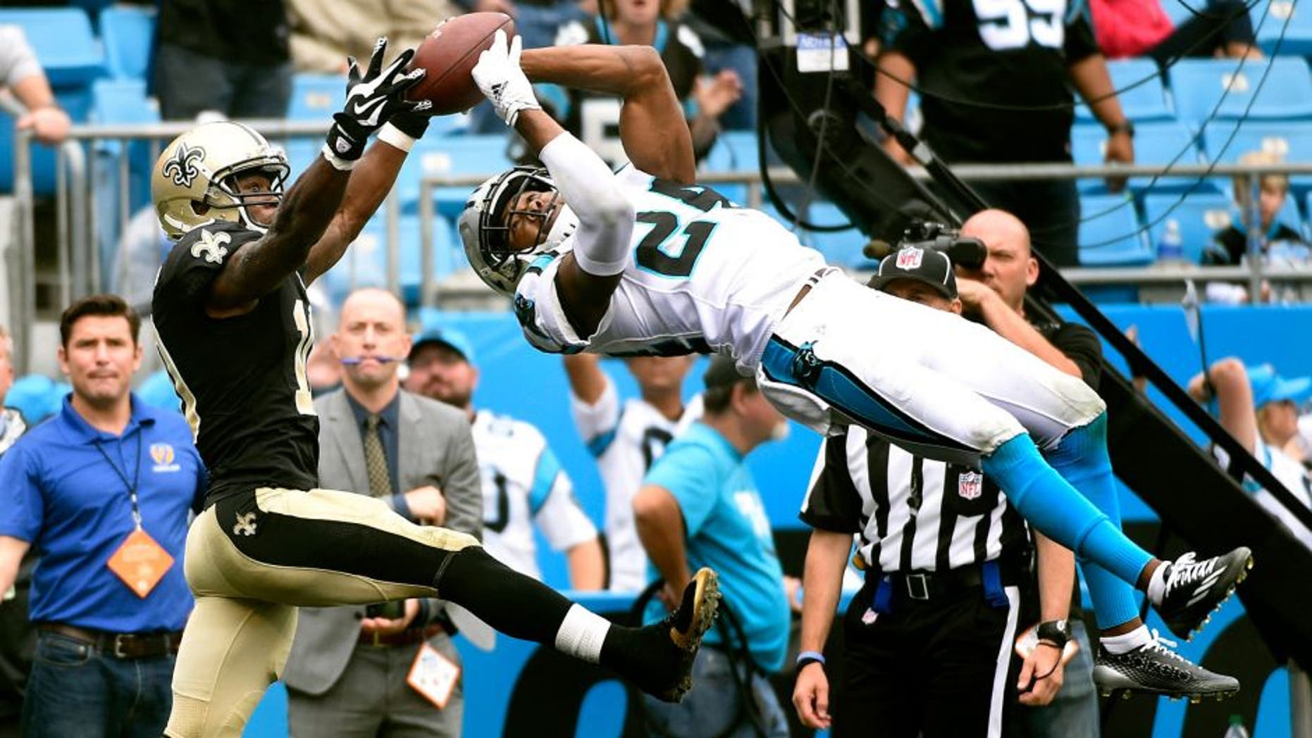 Sep 27, 2015; Charlotte, NC, USA; Carolina Panthers cornerback Josh Norman (24) intercepts a pass in the end zone intended for New Orleans Saints wide receiver Brandin Cooks (10) late in the fourth quarter. The Panthers defeated the Saints 27-22 at Bank of America Stadium. Mandatory Credit: Bob Donnan-USA TODAY Sports