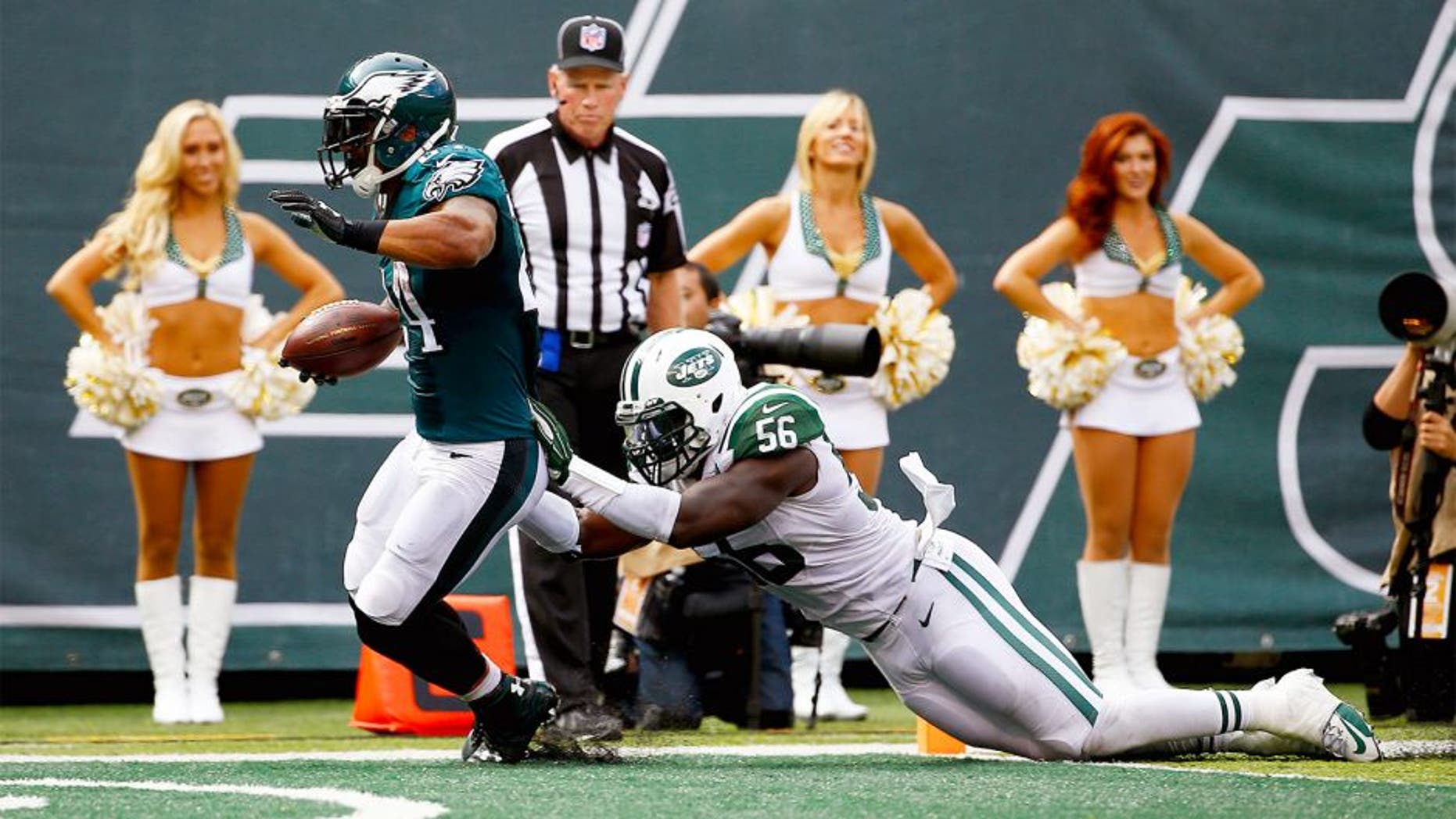 EAST RUTHERFORD, NJ - SEPTEMBER 27: Ryan Mathews #24 of the Philadelphia Eagles scores a touchdown in the second quarter as Demario Davis #56 of the New York Jets defends at MetLife Stadium on September 27, 2015 in East Rutherford, New Jersey. (Photo by Al Bello/Getty Images)