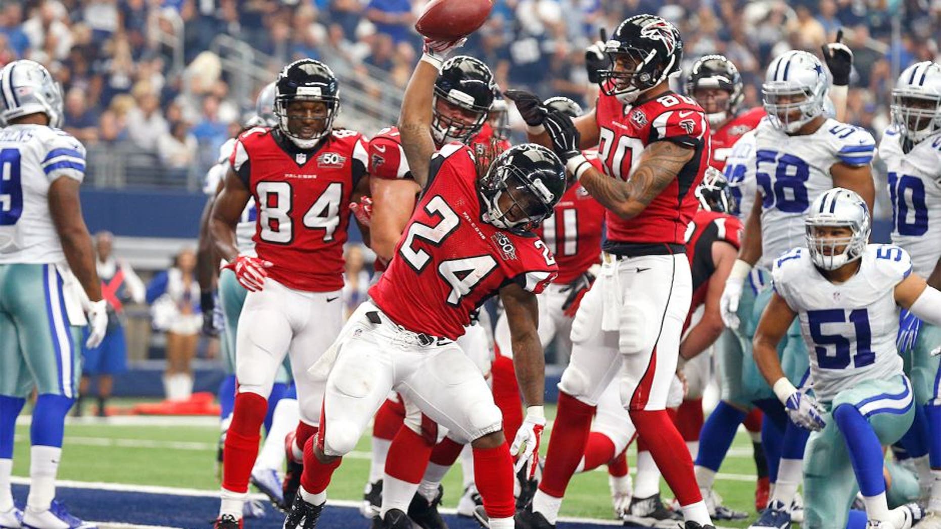 Sep 27, 2015; Arlington, TX, USA; Atlanta Falcons running back Devonta Freeman (24) spikes the ball after scoring a touchdown in the second quarter against the Dallas Cowboys at AT&T Stadium. Mandatory Credit: Matthew Emmons-USA TODAY Sports