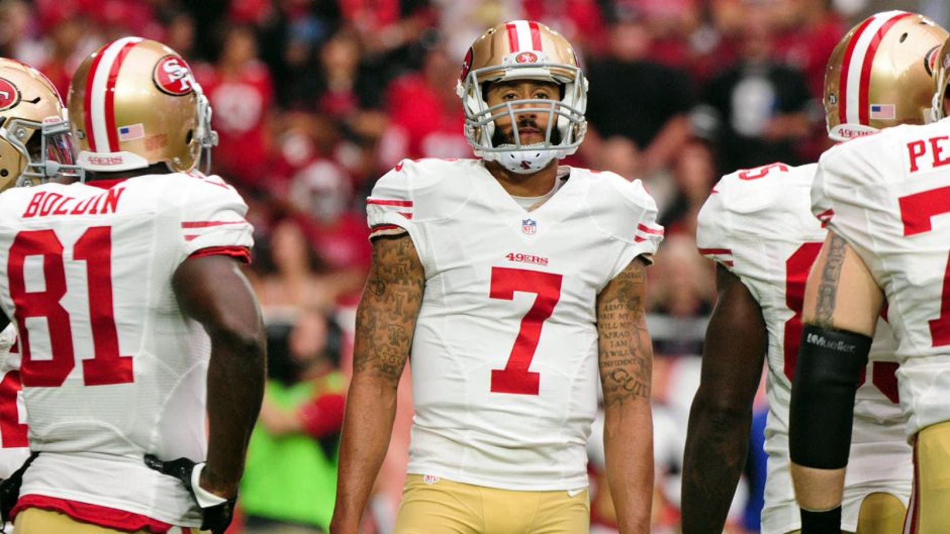 Sep 27, 2015; Glendale, AZ, USA; San Francisco 49ers quarterback Colin Kaepernick (7) looks on during the first half against the Arizona Cardinals at University of Phoenix Stadium. Mandatory Credit: Matt Kartozian-USA TODAY Sports