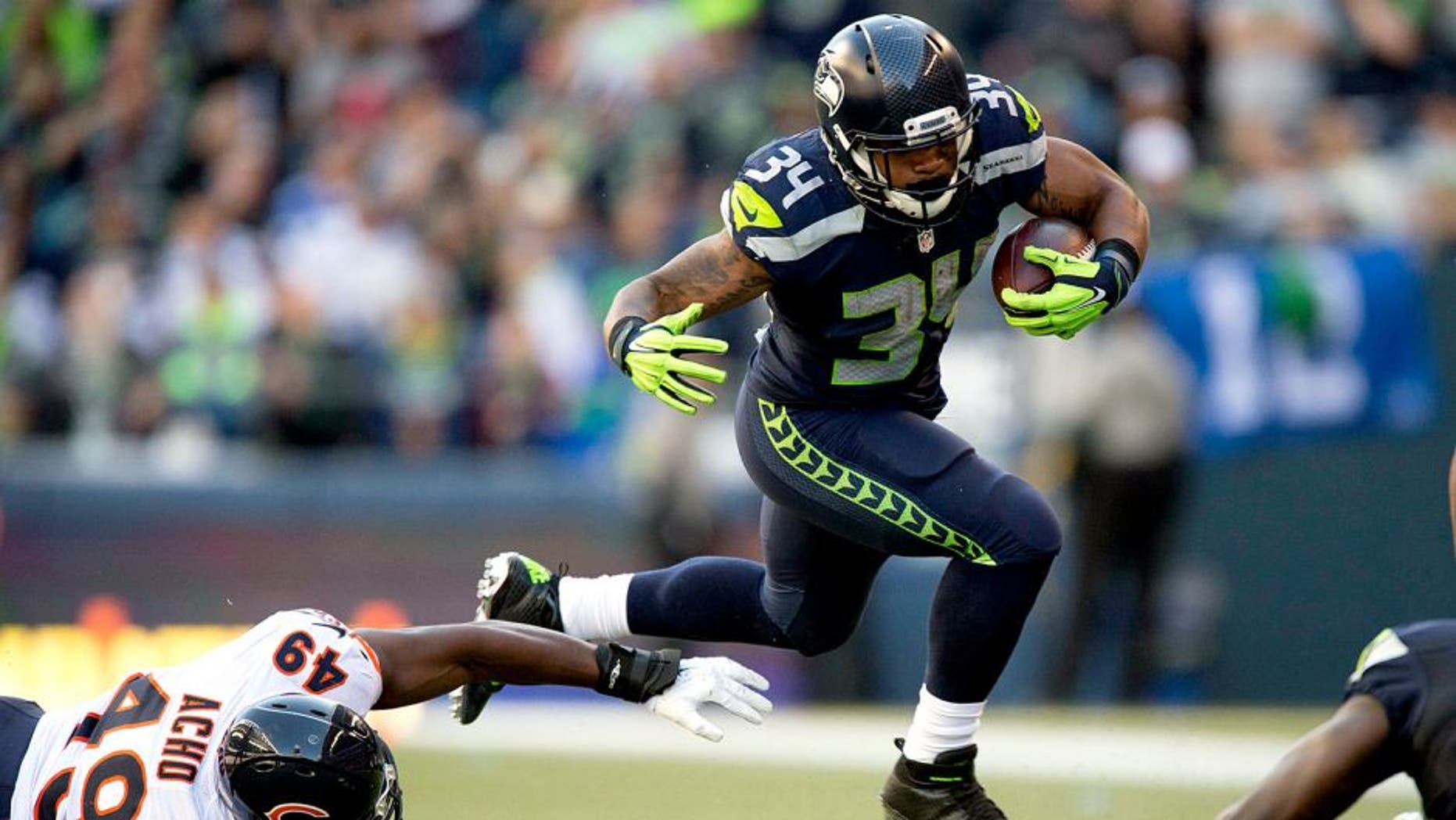 Sep 27, 2015; Seattle, WA, USA; Seattle Seahawks running back Thomas Rawls (34) breaks away from Chicago Bears linebacker Sam Acho (49) during the third quarter at CenturyLink Field. The Seahawks won 26-0. Mandatory Credit: Troy Wayrynen-USA TODAY Sports