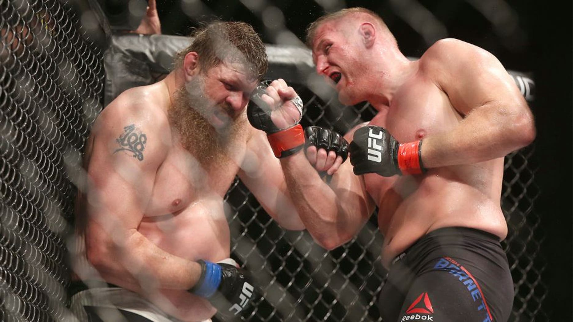 SAITAMA, JAPAN - SEPTEMBER 27: Josh Barnett of USA (R) throws a punch against Roy Nelson of USA in their heavyweight bought during UFC Fight Night at Saitama Super Arena on September 27, 2015 in Saitama, Japan. (Photo by Ken Ishii/Getty Images)