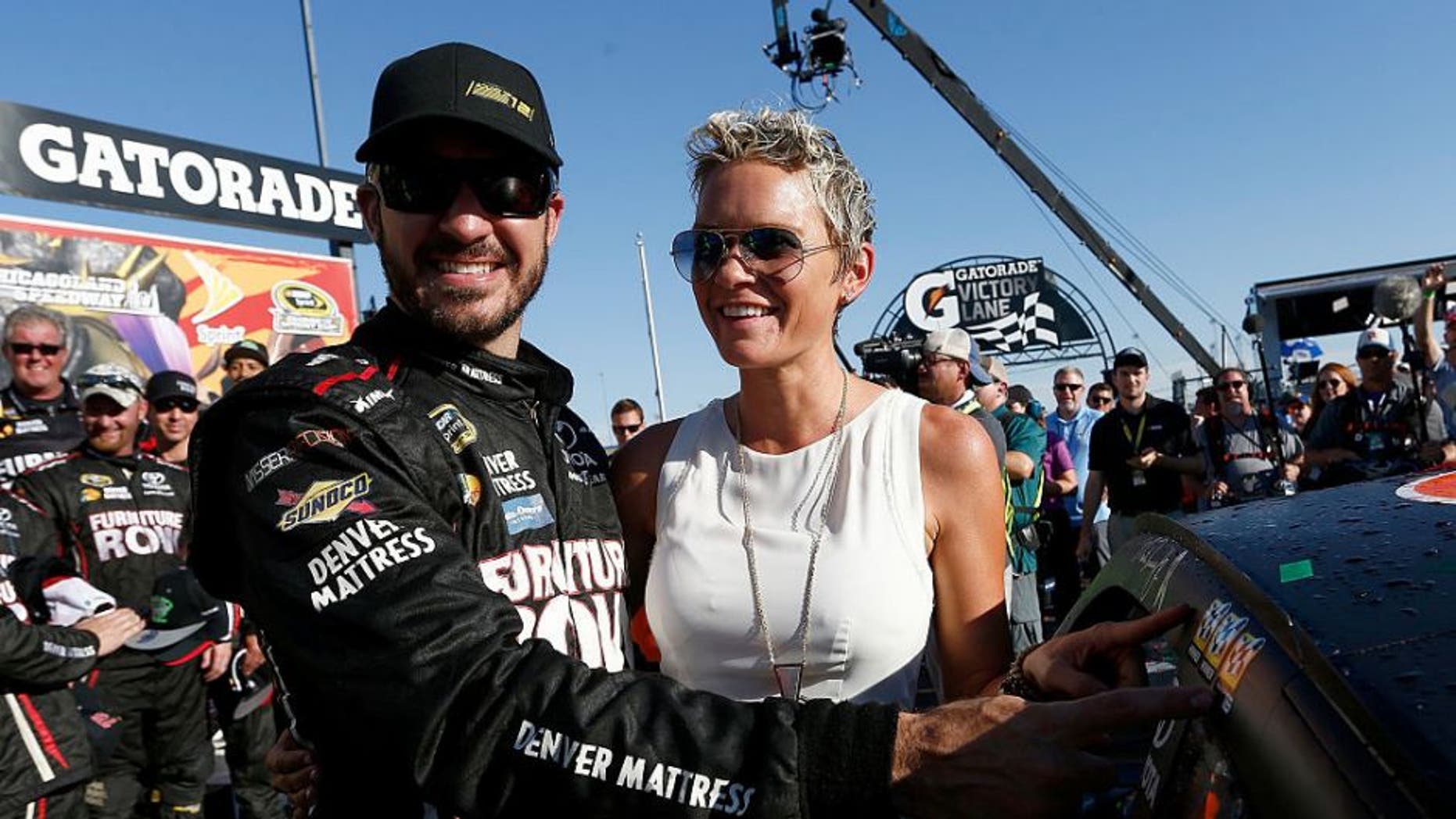 JOLIET, IL - SEPTEMBER 18: Martin Truex Jr, driver of the #78 Furniture Row/Denver Mattress Toyota, and his wife Sherry Pollex celebrate in Victory Lane during the NASCAR Sprint Cup Series Teenage Mutant Ninja Turtles 400 at Chicagoland Speedway on September 18, 2016 in Joliet, Illinois. (Photo by Jeff Zelevansky/NASCAR via Getty Images)