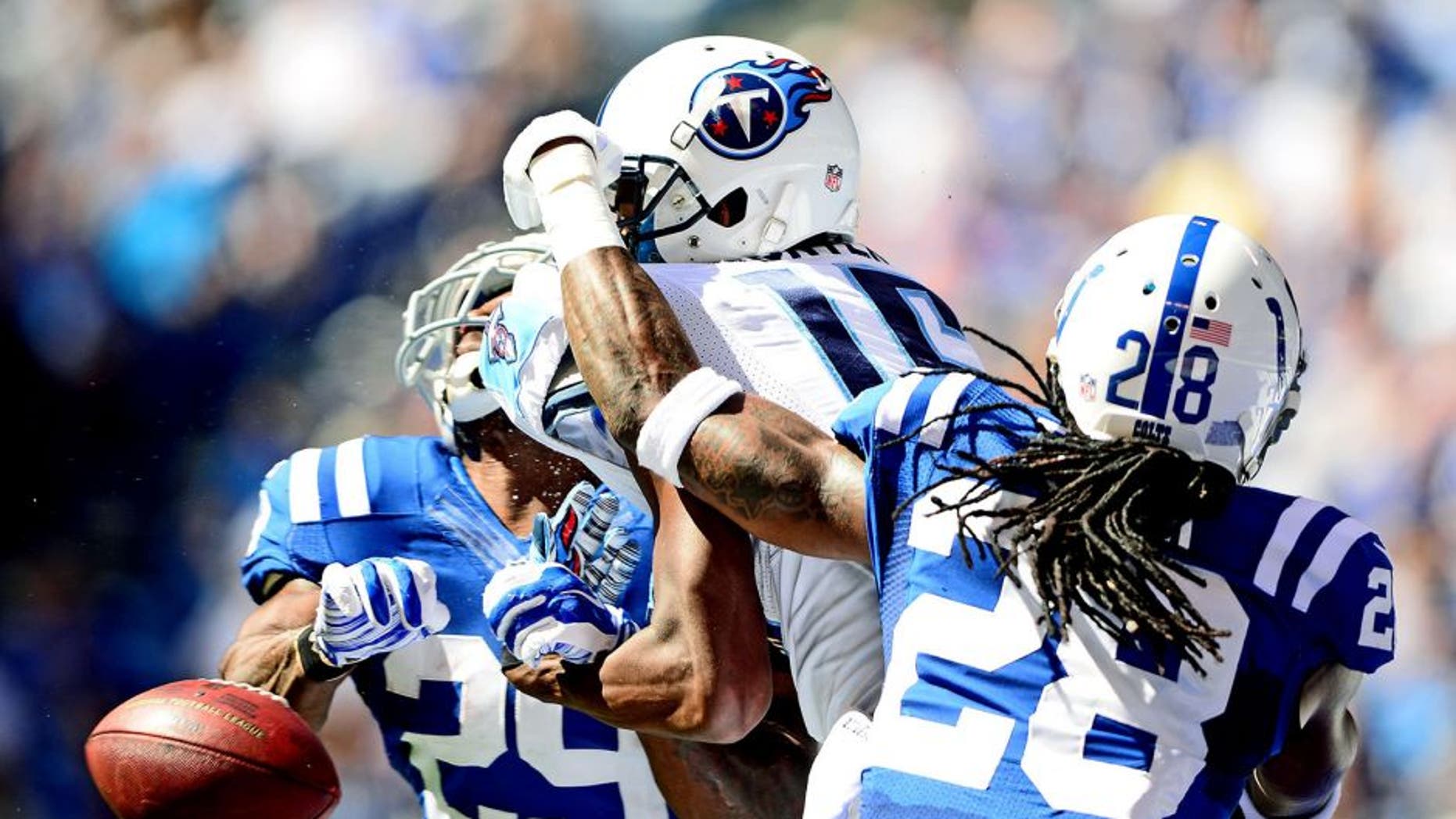 Sep 28, 2014; Indianapolis, IN, USA; Tennessee Titans wide receiver Justin Hunter (15) is unable to make a catch while being defended by Indianapolis Colts strong safety Mike Adams (29) and cornerback Greg Toler (28)during the second quarter at Lucas Oil Stadium. Mandatory Credit: Andrew Weber-USA TODAY Sports