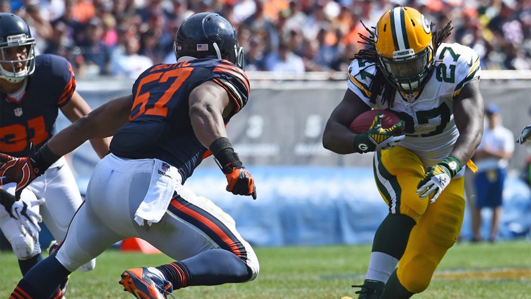 Sep 28, 2014; Chicago, IL, USA; Green Bay Packers running back Eddie Lacy (27) rushes the ball against Chicago Bears inside linebacker Jon Bostic (57) during the second half at Soldier Field. The Green Bay Packers defeats the Chicago Bears 38-17. Mandatory Credit: Mike DiNovo-USA TODAY Sports