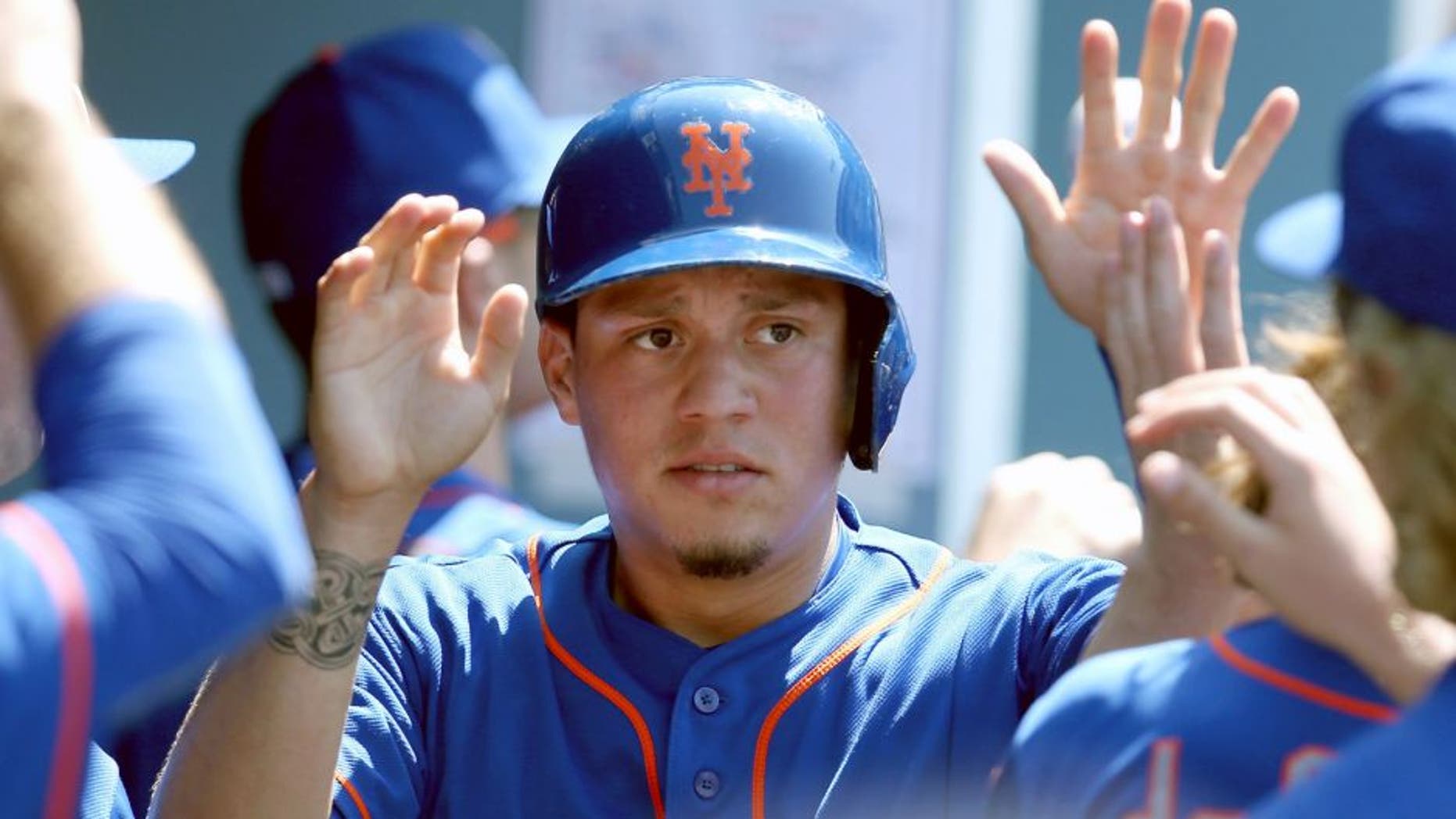 LOS ANGELES, CA - JULY 05: Wilmer Flores #4 of the New York Mets celebrates in the dugout after scoring a run against the Los Angeles Dodgers at Dodger Stadium on July 5, 2015 in Los Angeles, California. (Photo by Stephen Dunn/Getty Images)