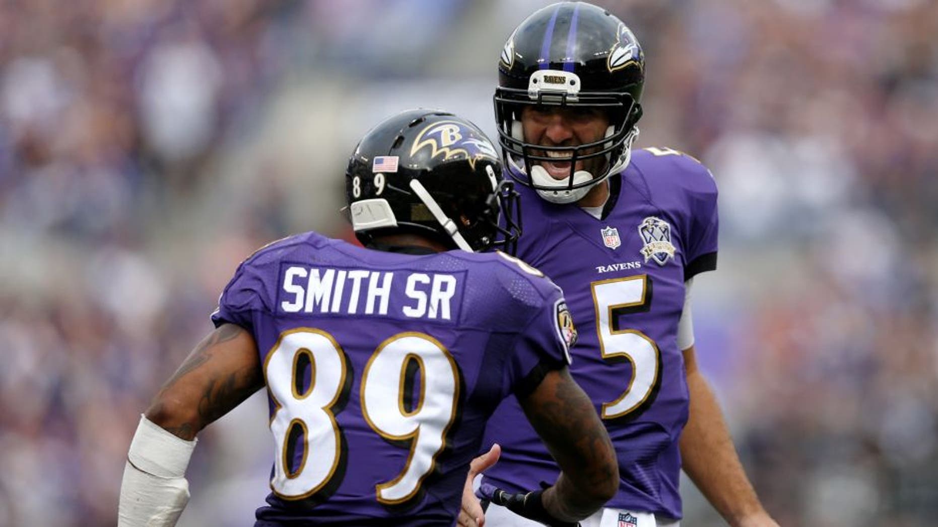 BALTIMORE, MD - SEPTEMBER 27: Wide receiver Steve Smith #89 of the Baltimore Ravens celebrates with quarterback Joe Flacco #5 of the Baltimore Ravens after scoring a fourth quarter touchdown during a game against the Cincinnati Bengals at M&T Bank Stadium on September 27, 2015 in Baltimore, Maryland. (Photo by Patrick Smith/Getty Images)