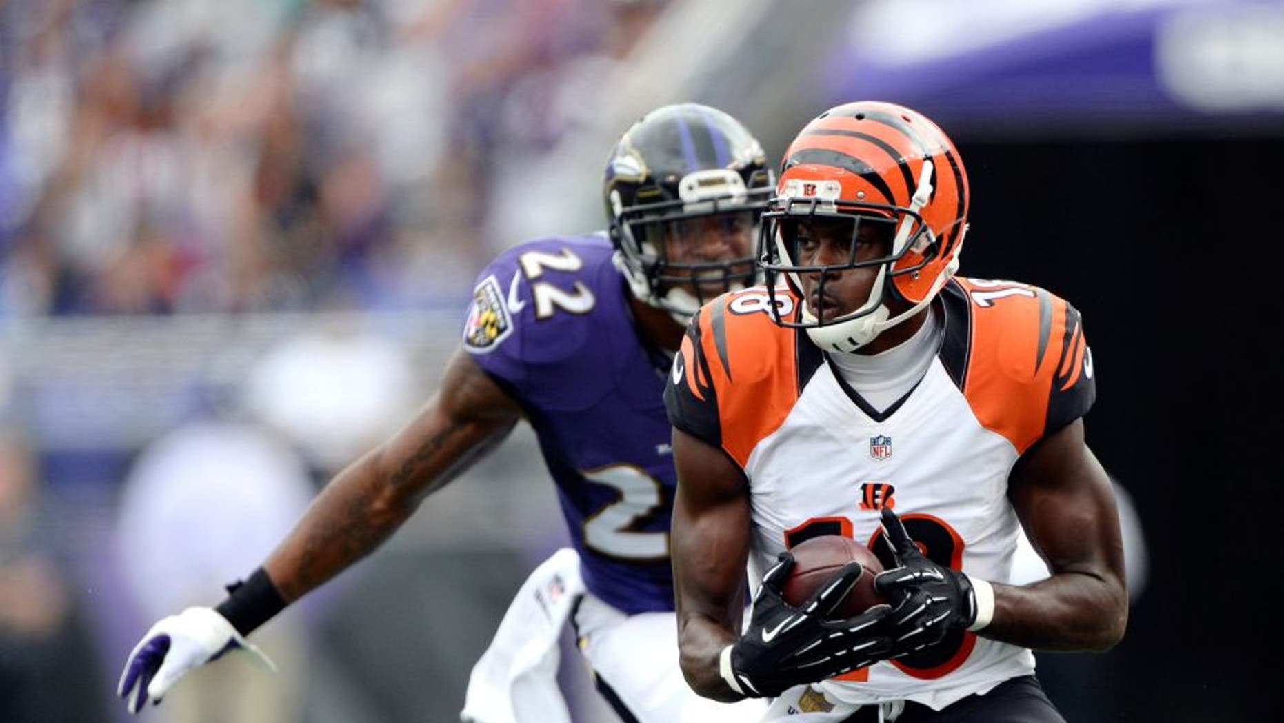 Sep 27, 2015; Baltimore, MD, USA; Cincinnati Bengals wide receiver A.J. Green (18) runs after the catch as Baltimore Ravens cornerback Jimmy Smith (22) defends during the second quarter at M&T Bank Stadium. Mandatory Credit: Tommy Gilligan-USA TODAY Sports
