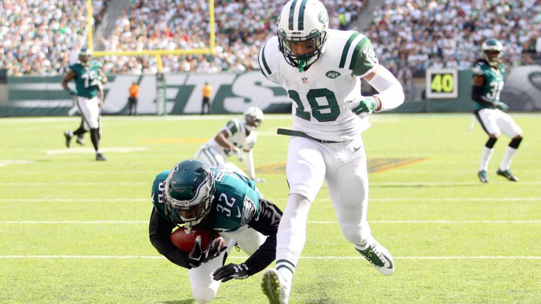 Sep 27, 2015; East Rutherford, NJ, USA; Philadelphia Eagles defensive back Eric Rowe (32) intercepts a pass intended for New York Jets wide receiver Devin Smith (19) and rolls into the end zone for a touchback during the third quarter at MetLife Stadium. Mandatory Credit: Brad Penner-USA TODAY Sports