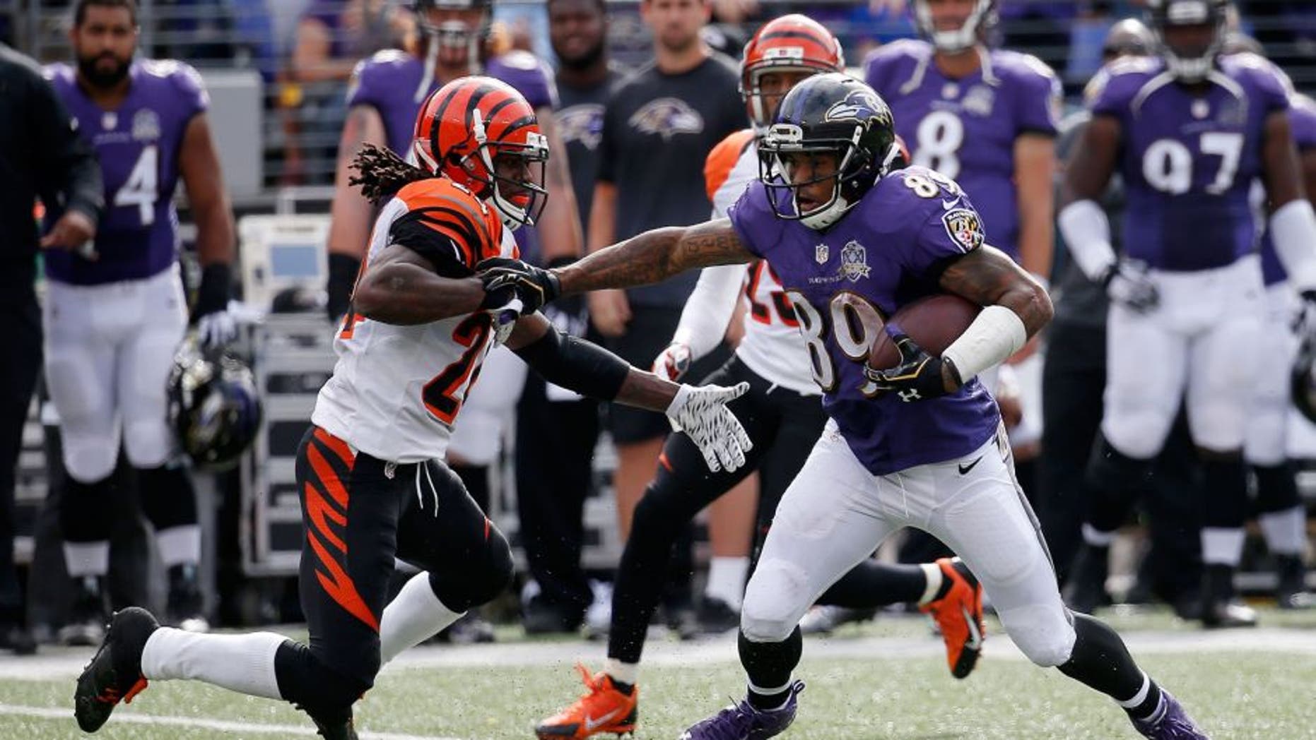 BALTIMORE, MD - SEPTEMBER 27: Wide receiver Steve Smith #89 of the Baltimore Ravens carries the ball while cornerback Adam Jones #24 of the Cincinnati Bengals defends in the third quarter of a game at M&T Bank Stadium on September 27, 2015 in Baltimore, Maryland. (Photo by Rob Carr/Getty Images)