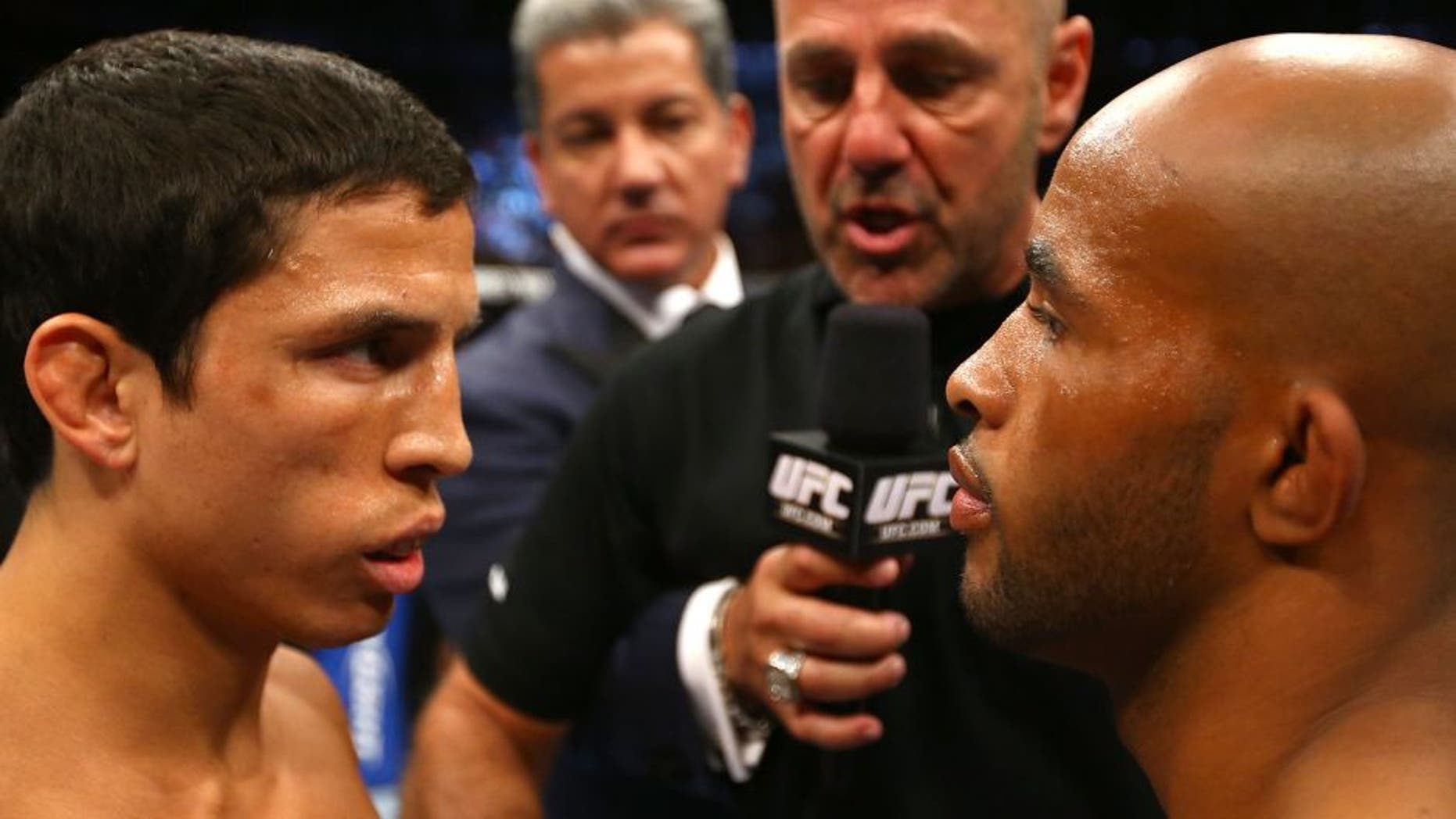 TORONTO, CANADA - SEPTEMBER 22: Opponents Joseph Benavidez (L) and Demetrious Johnson (R) receive final instructions from referee Yves Lavigne before their flyweight championship bout at UFC 152 inside Air Canada Centre on September 22, 2012 in Toronto, Ontario, Canada. (Photo by Al Bello/Zuffa LLC/Zuffa LLC via Getty Images)