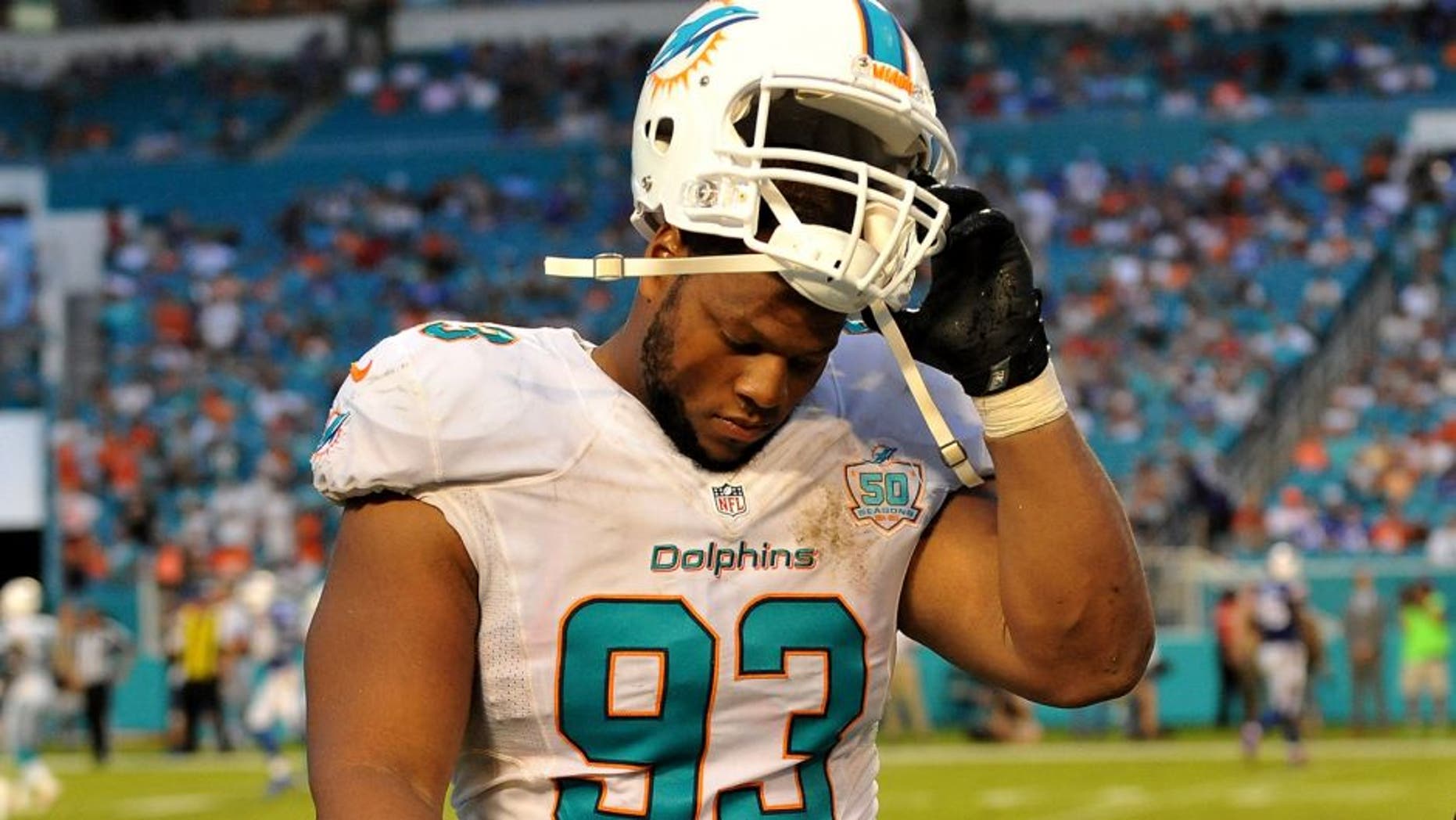 Sep 27, 2015; Miami Gardens, FL, USA; Miami Dolphins defensive tackle Ndamukong Suh (93) walks back to the sideline during the second half against the Buffalo Bills at Sun Life Stadium. Mandatory Credit: Steve Mitchell-USA TODAY Sports