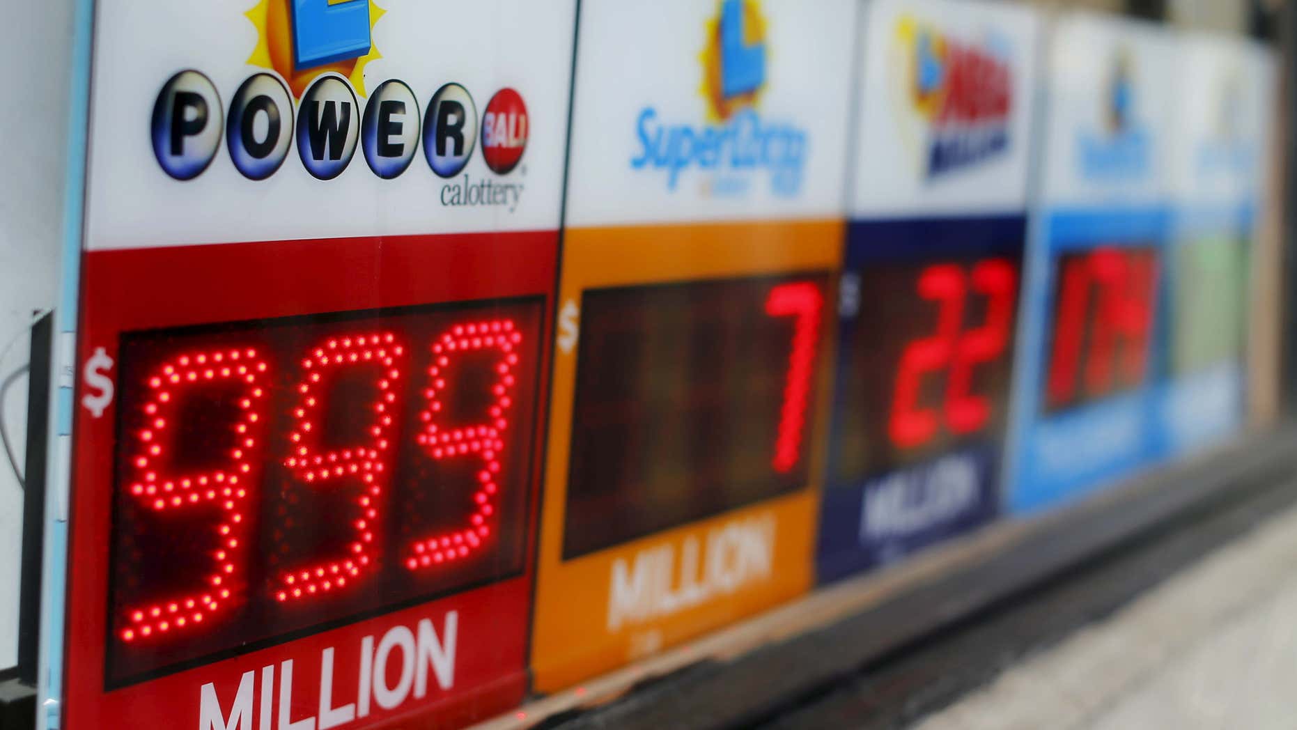 Jan. 13, 2016: A Powerball sign shows $999 million outside a corner corner store in San Diego.