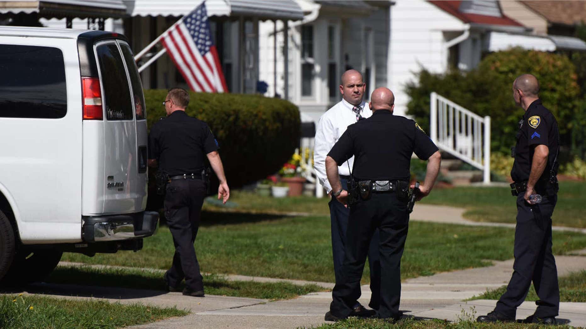 Police investigate at a home where two children were shot in Dearborn, Mich., Wednesday, Sept. 27, 2017.
