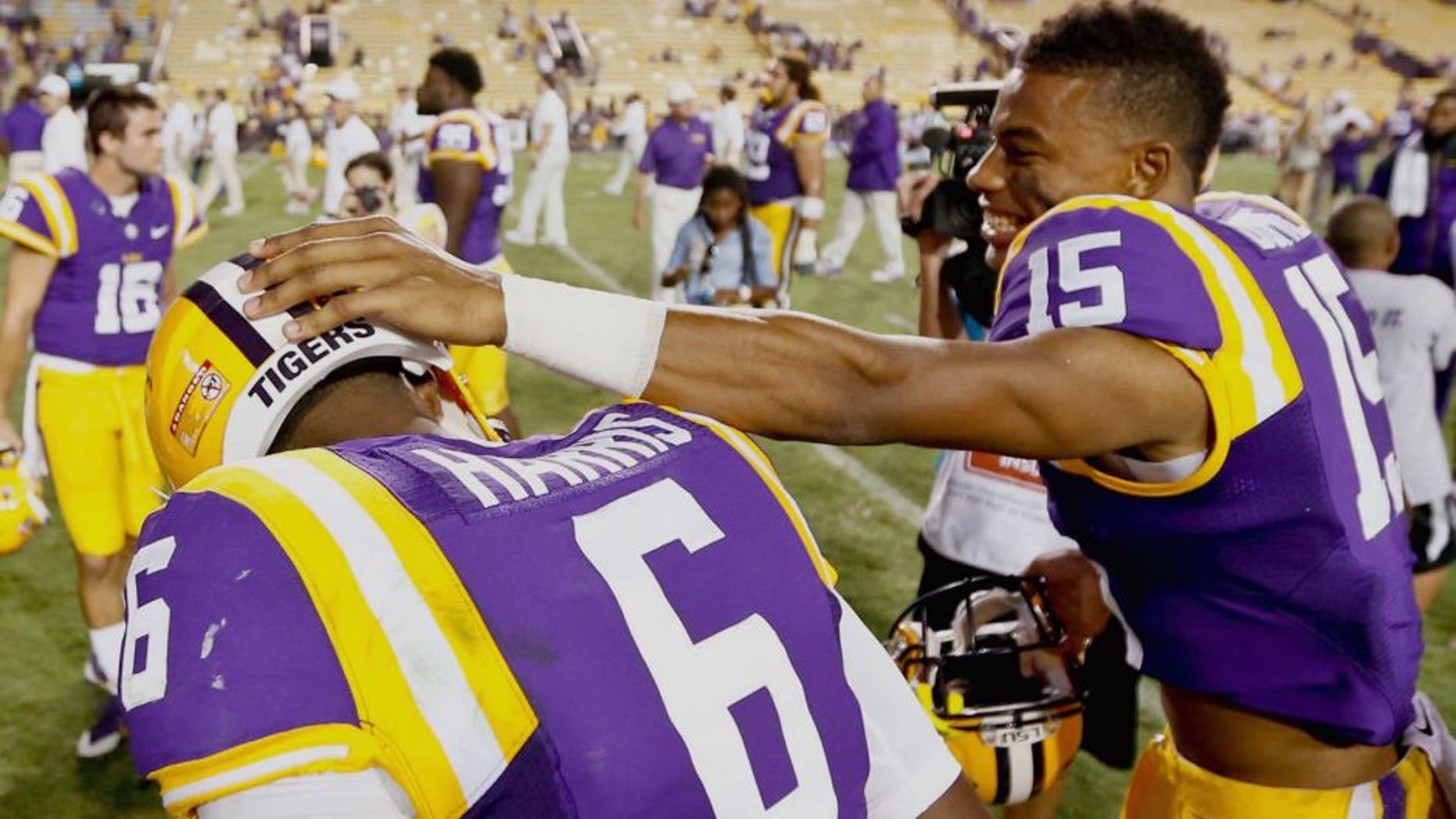 Sep 27, 2014; Baton Rouge, LA, USA; LSU Tigers wide receiver Malachi Dupre (15) and quarterback Brandon Harris (6) celebrate following a win against the New Mexico State Aggies in a game at Tiger Stadium. LSU defeated New Mexico State 63-7. Mandatory Credit: Derick E. Hingle-USA TODAY Sports