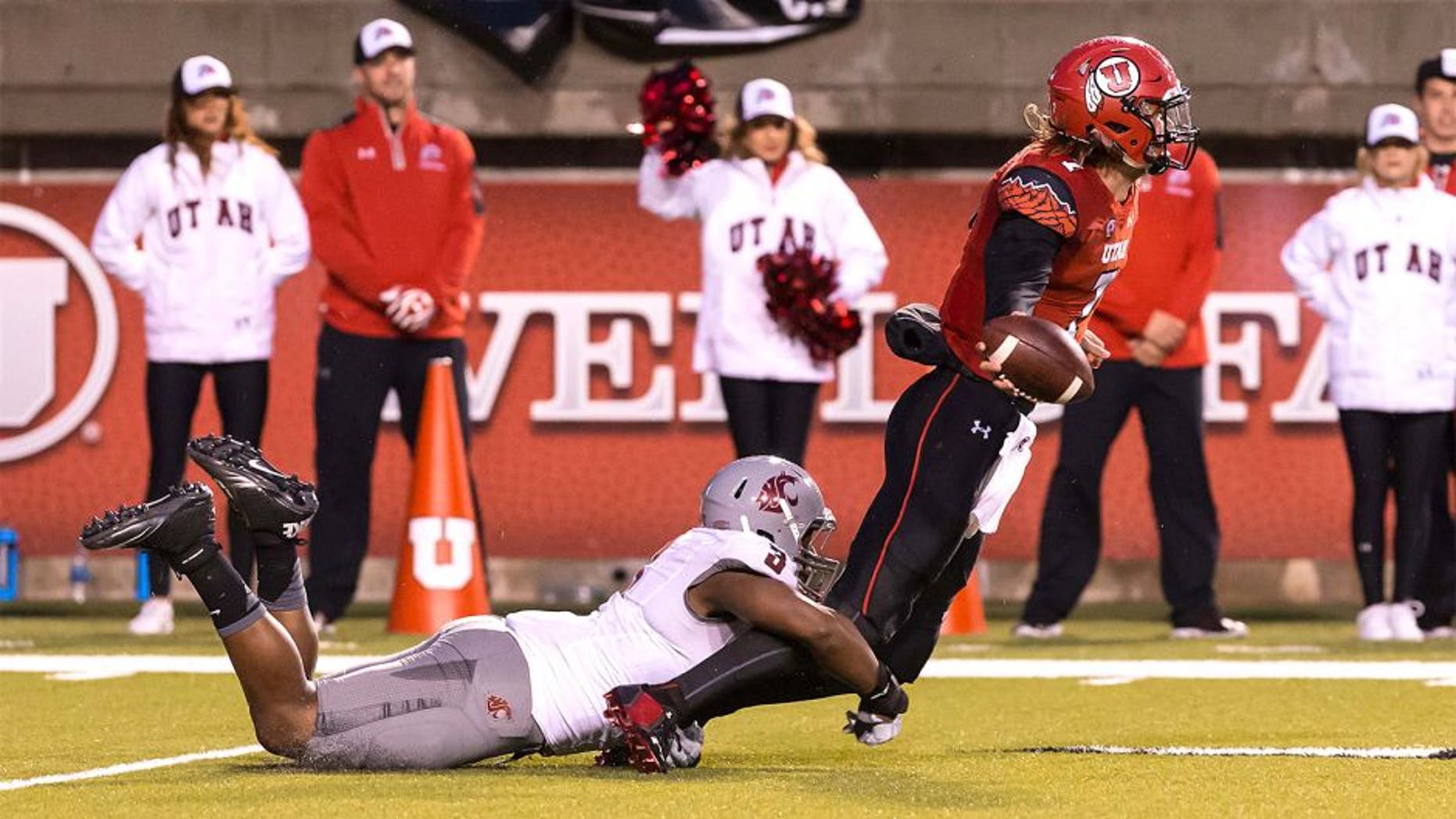 Sep 27, 2014; Salt Lake City, UT, USA; Utah Utes quarterback Travis Wilson (7) tries to get rid of the ball before being tackled by Washington State Cougars linebacker Ivan McLennan (3) during the first half at Rice-Eccles Stadium. Mandatory Credit: Chris Nicoll-USA TODAY Sports