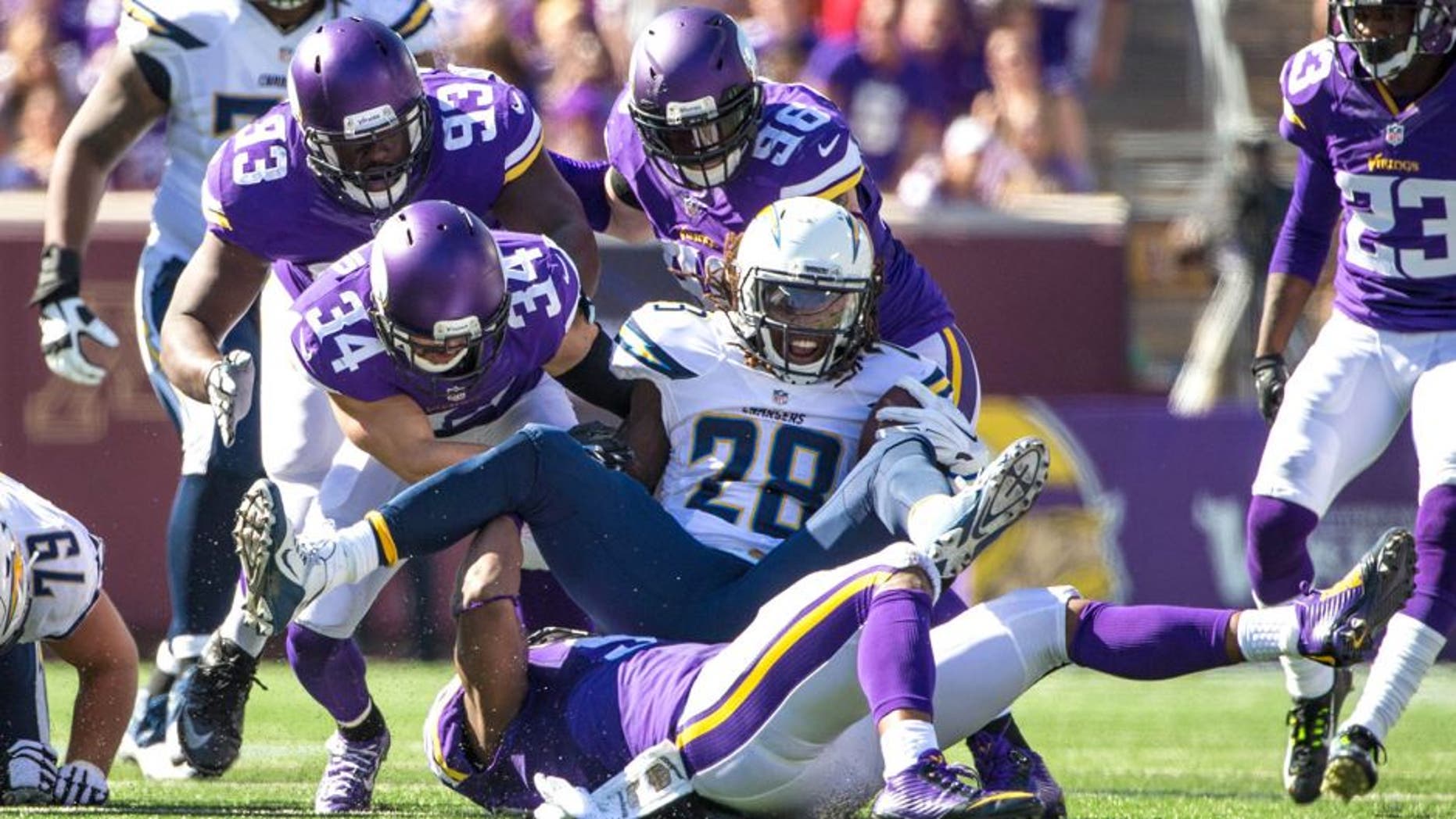 Sep 27, 2015; Minneapolis, MN, USA; San Diego Chargers running back Melvin Gordon (28) is tackled by Minnesota Vikings safety Andrew Sendejo (34) during the third quarter at TCF Bank Stadium. The Vikings defeated the Chargers 31-14. Mandatory Credit: Brace Hemmelgarn-USA TODAY Sports