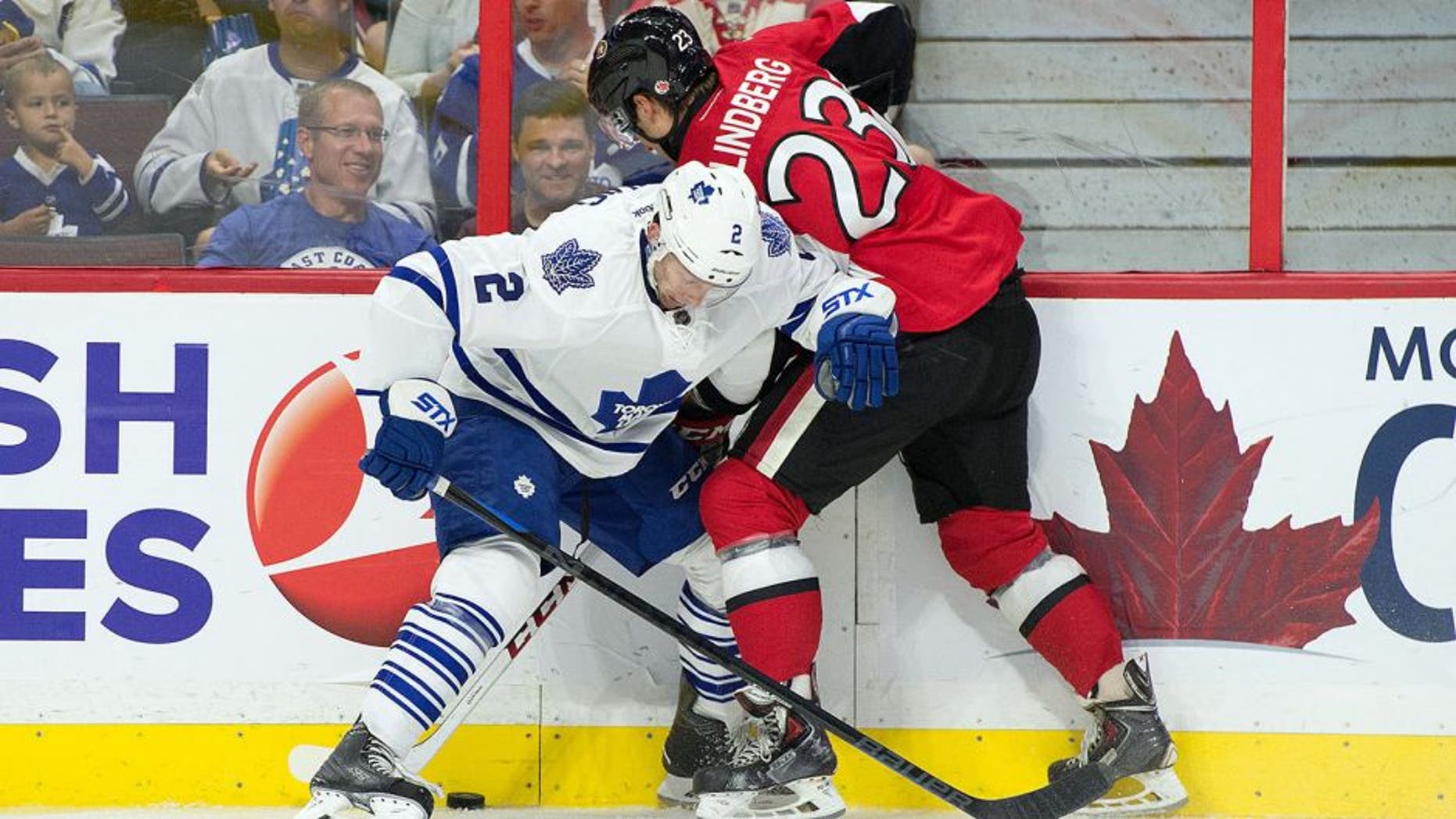 Sep 21, 2015; Ottawa, Ontario, CAN; Toronto Maple Leafs defenseman Matt Hunwick (2) and Ottawa Senators ight wing Tobias Lindberg (23) battle for the puck in the second period at Canadian Tire Centre. Mandatory Credit: Marc DesRosiers-USA TODAY Sports