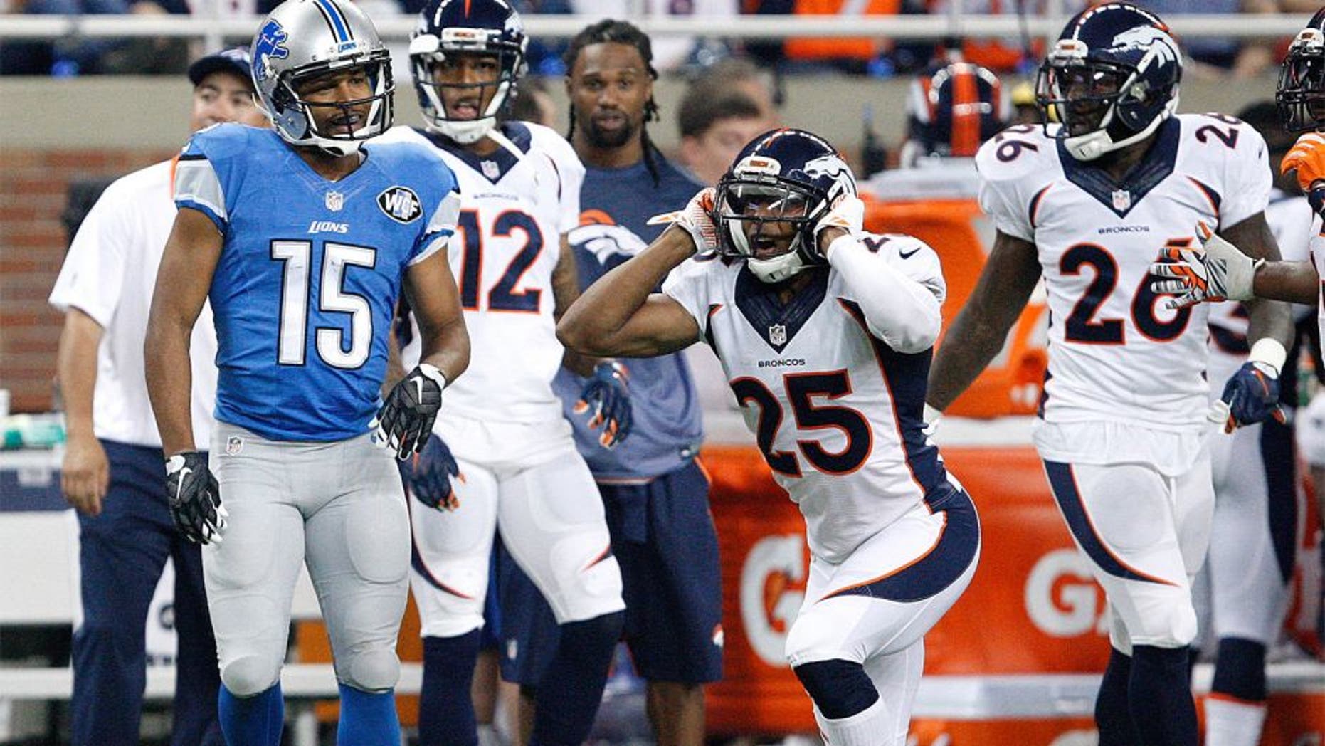 Sep 27, 2015; Detroit, MI, USA; Denver Broncos cornerback Chris Harris (25) reacts after a call in front of Detroit Lions wide receiver Golden Tate (15) during the first quarter at Ford Field. Mandatory Credit: Raj Mehta-USA TODAY Sports