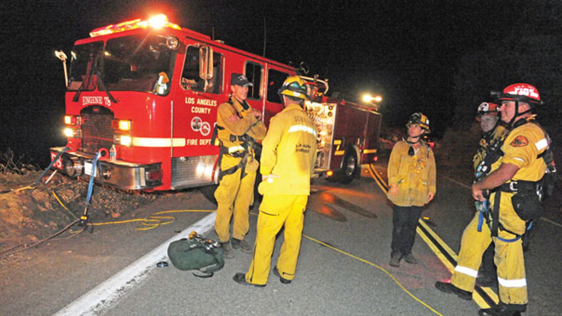 Sept. 29: Los Angeles County firefighters are stationed on Lake Hughes Road, where two vehicles were found off the side and approximately 200 feet in the canyon below in the Angeles National Forest, north of Castaic, Calif.